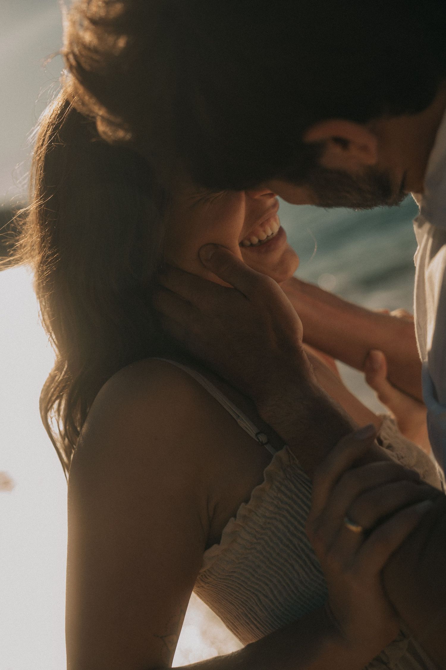 A romantic silhouette photo sequence shows an intimate couple sharing tender kisses in warm sunlight.