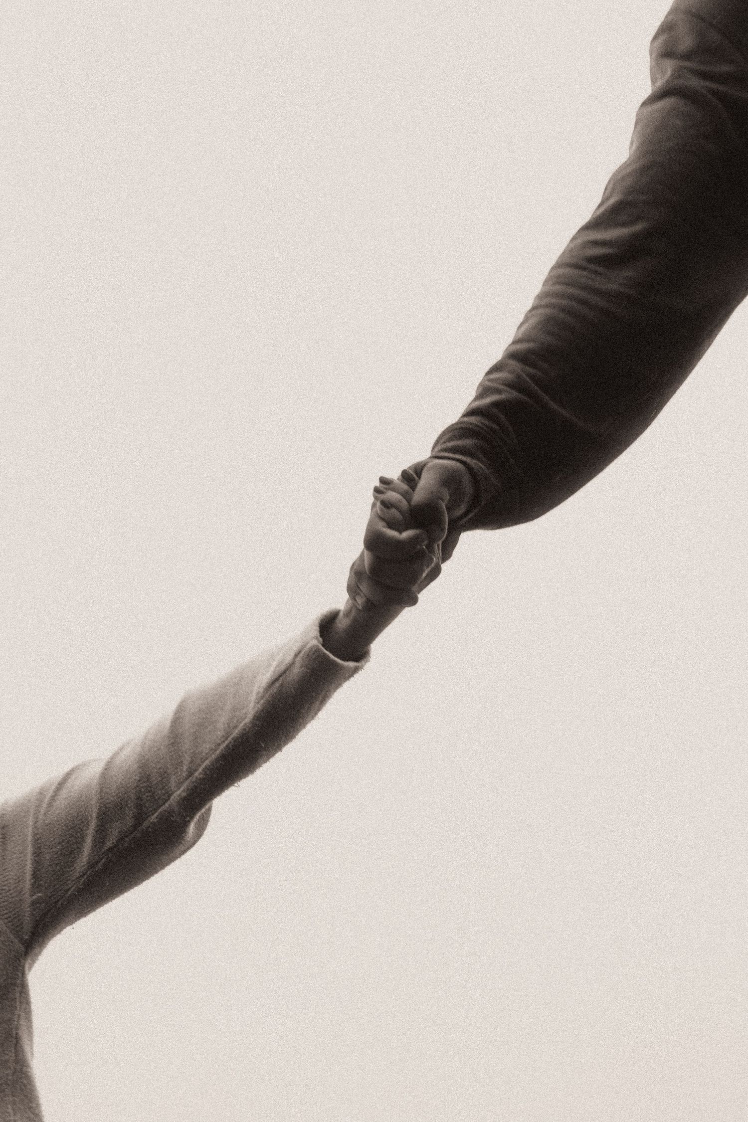 A series of black and white connected images showing a person's arm in motion against a light background.