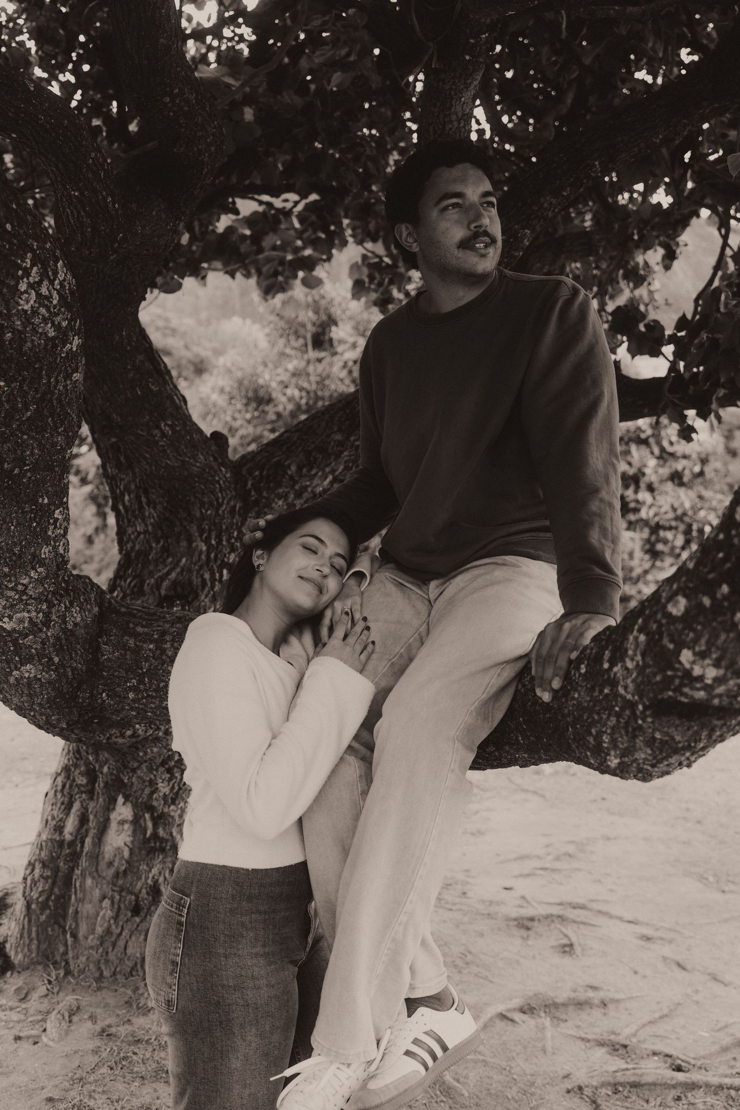 A romantic black and white portrait sequence showing an intimate couple posing against a tree in an artistic style.