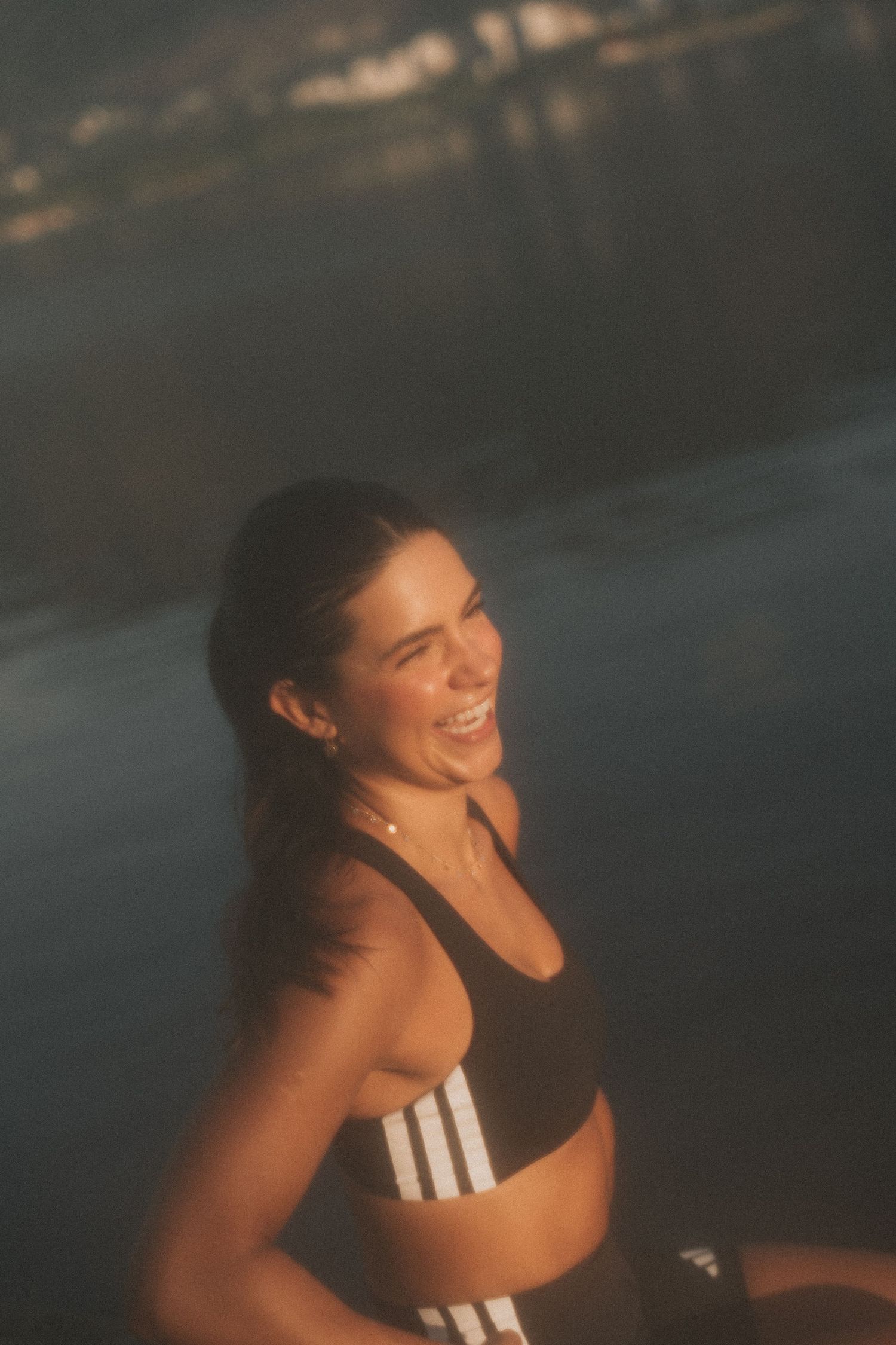 A person wearing a black sports bra smiles and moves during sunset in a collection of sequential action shots.