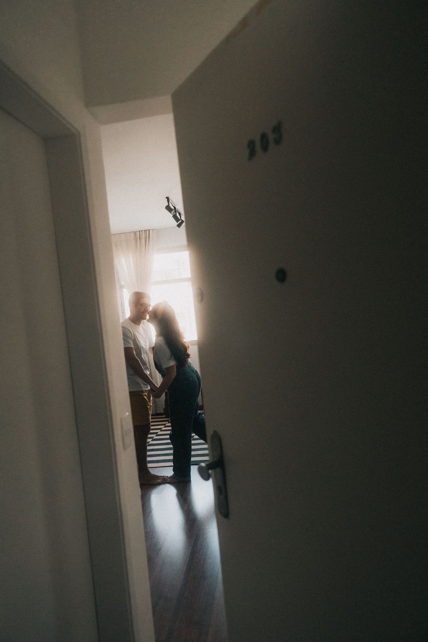 Three dark moody interior photos showing silhouettes of figures standing near a doorway with bright natural backlighting.