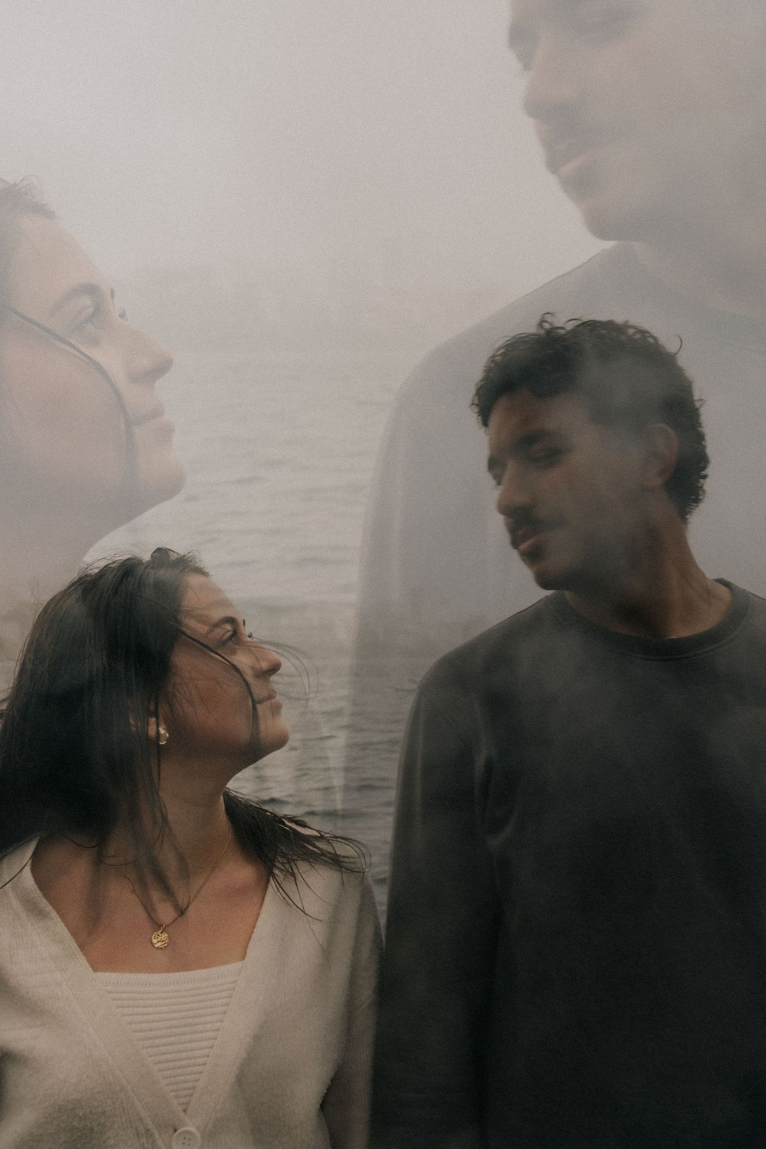 Intimate black and white photo series of a couple in tender romantic moments by the water.
