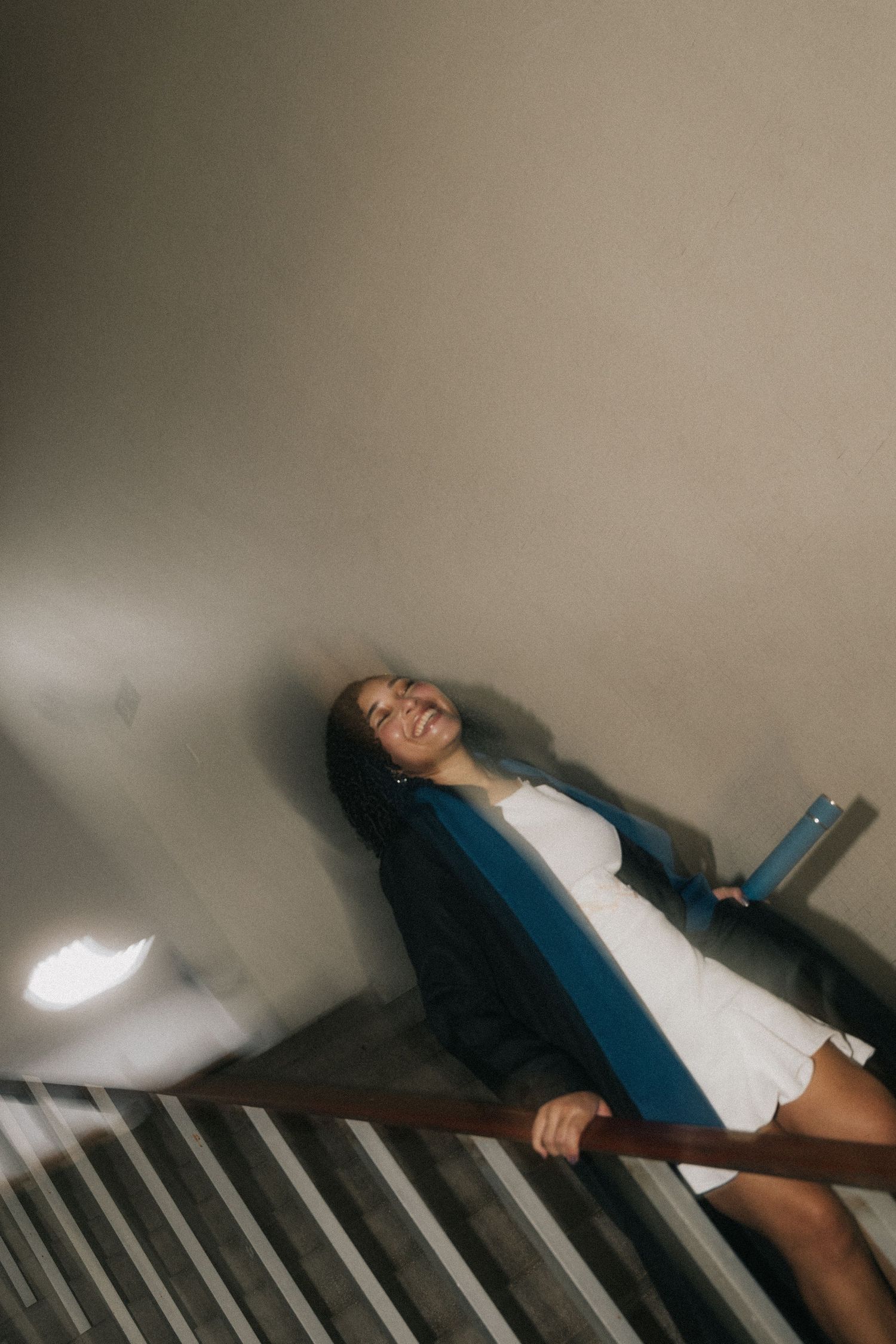 A person dressed in white and blue lounges back in a moody sequence of dynamic photographic frames.