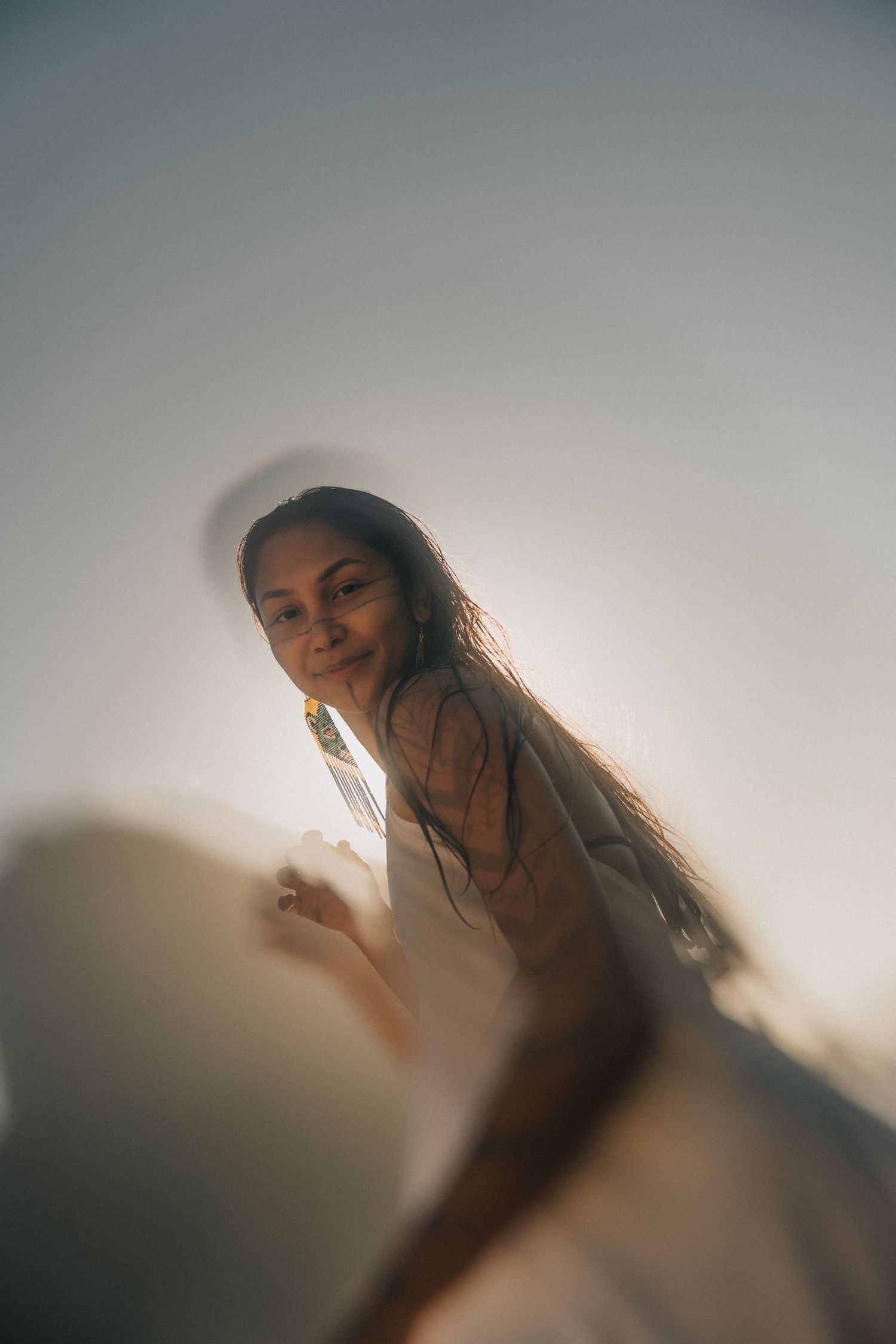 A series of ethereal portraits with soft lighting and dreamy atmosphere shows someone posing against a light backdrop.