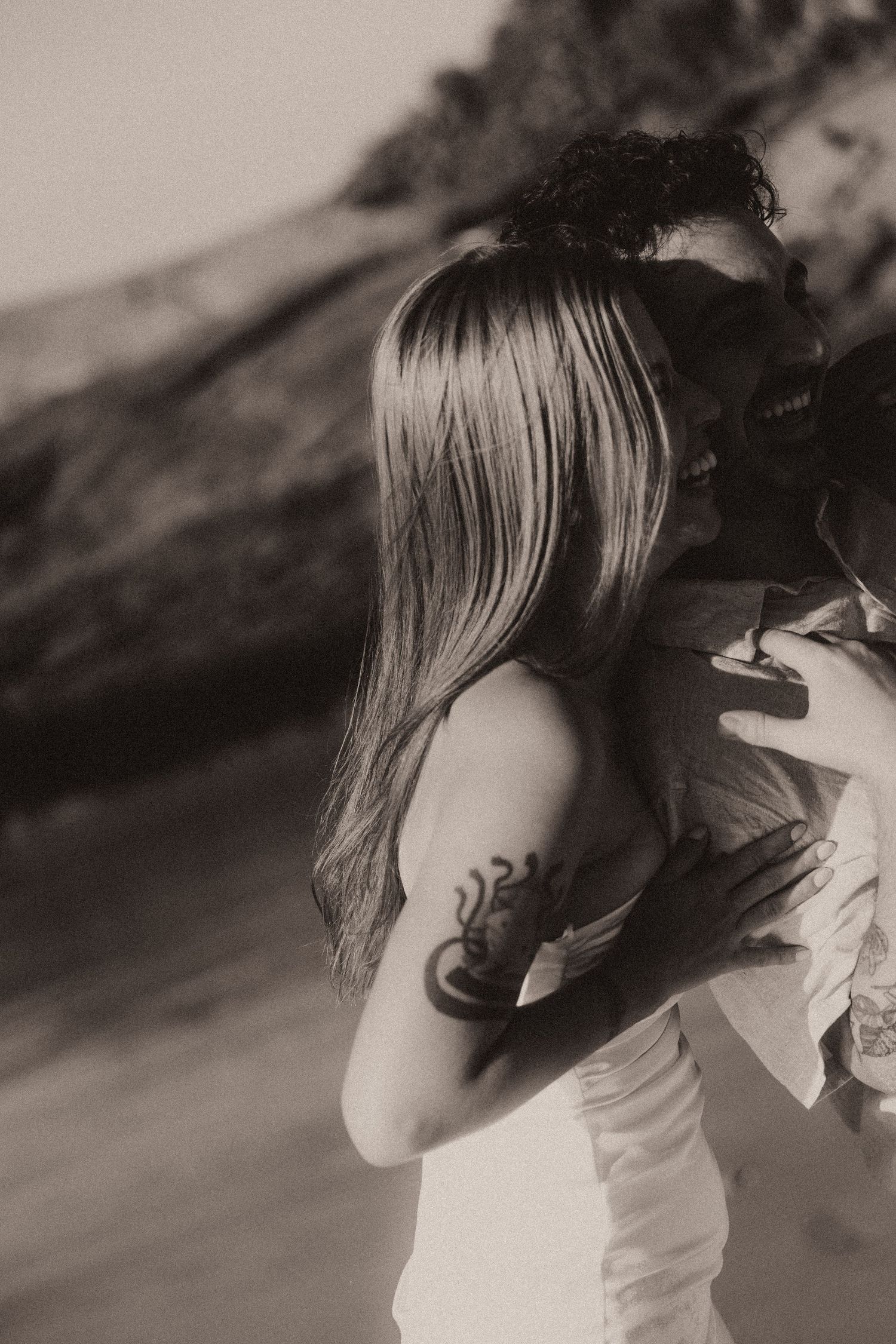 Four black and white artistic photographs show someone from behind with long flowing hair in ethereal movement.