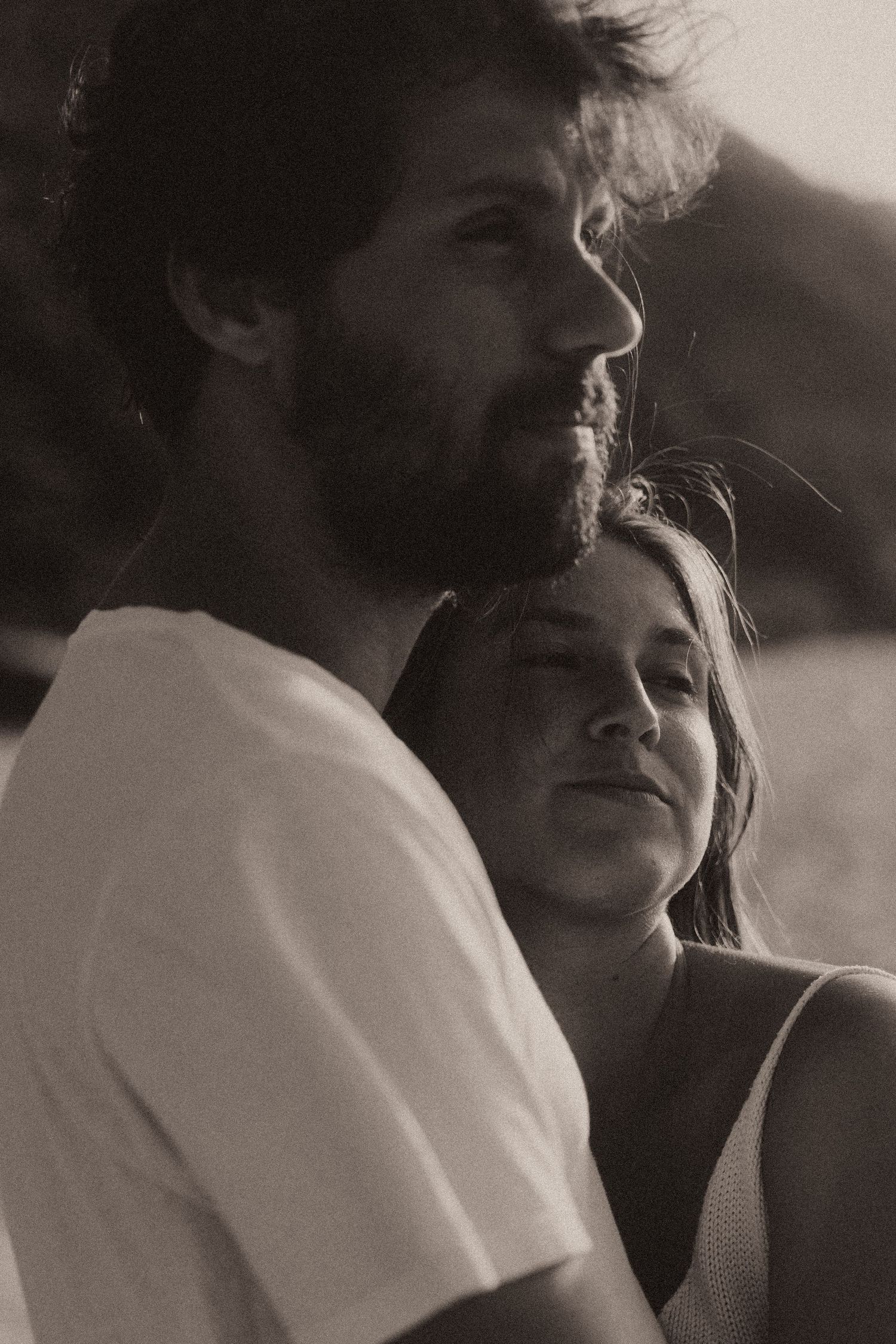 A black and white close-up photo sequence showing an intimate moment between two people in profile.