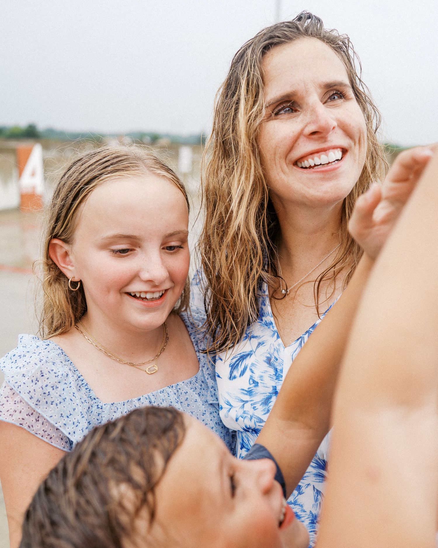 Family members share joyful moments together during a beach photoshoot.