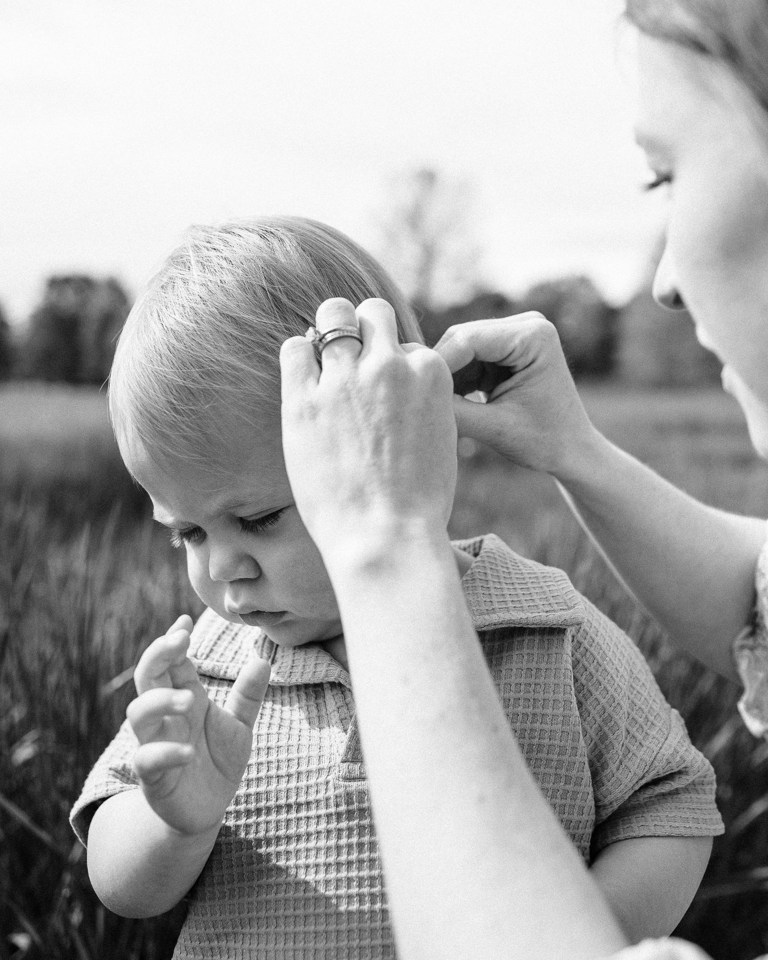 Black and white close-up shots of baby exploring and touching with curiosity.