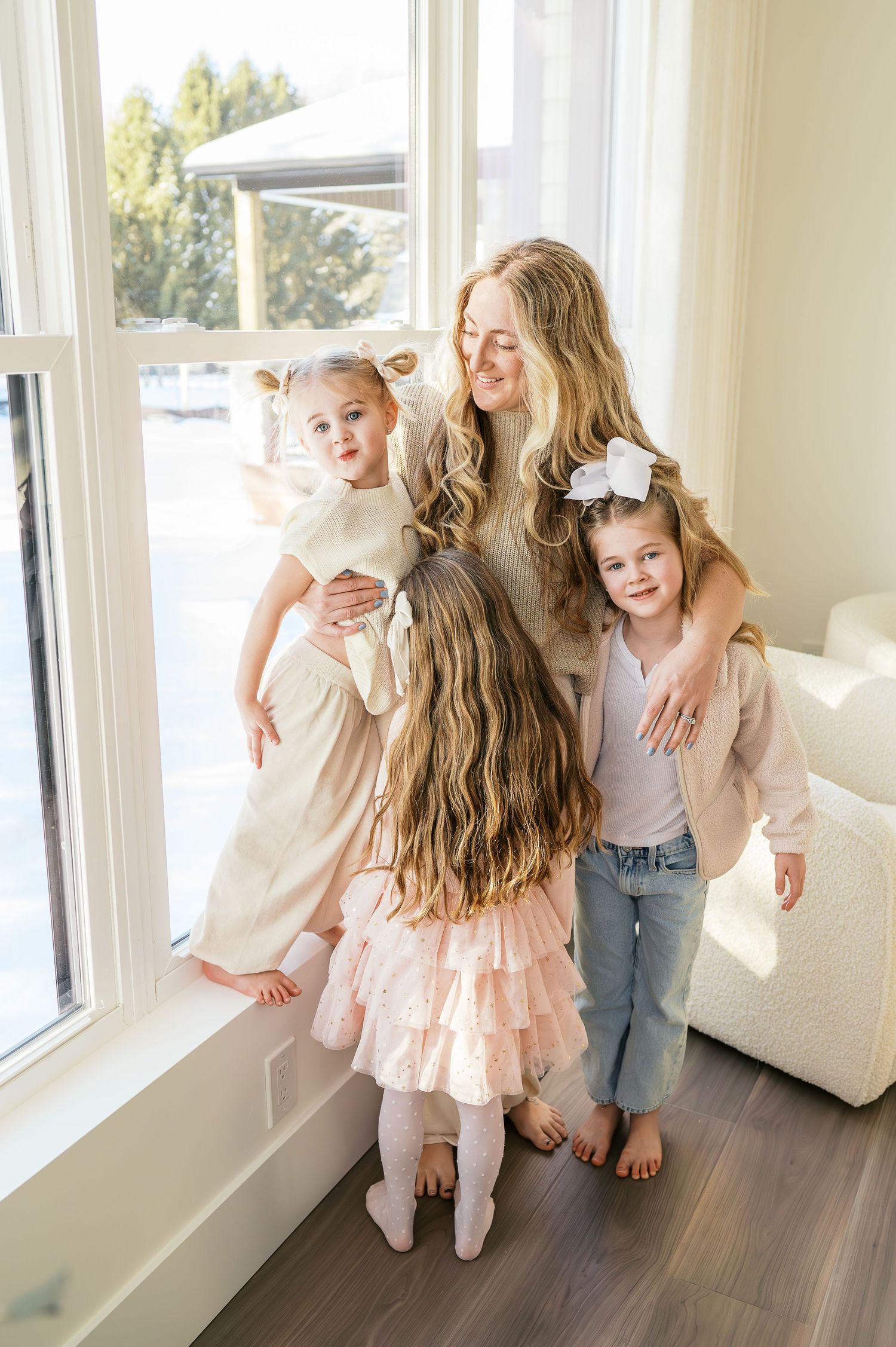 Series of joyful indoor family moments captured near bright windows with natural lighting.