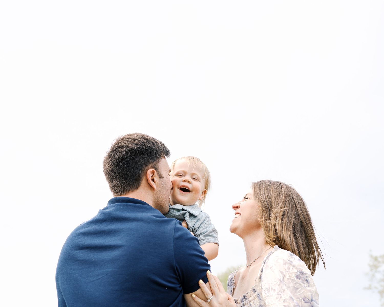 Candid family photography sequence showing intimate moments against a bright sky background.