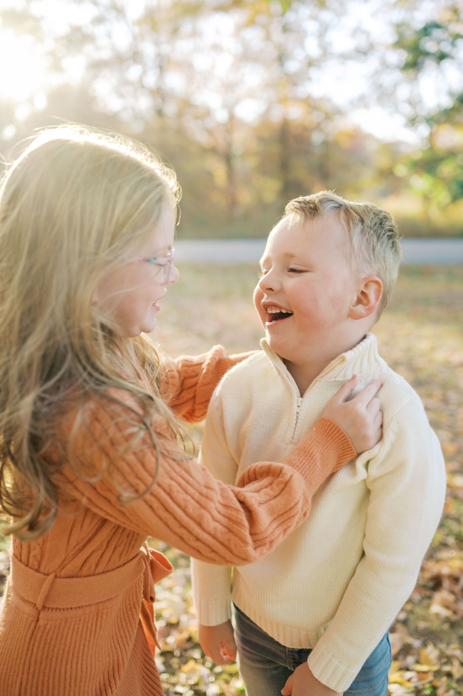 Candid moments of laughter and play against a backdrop of golden fall foliage.