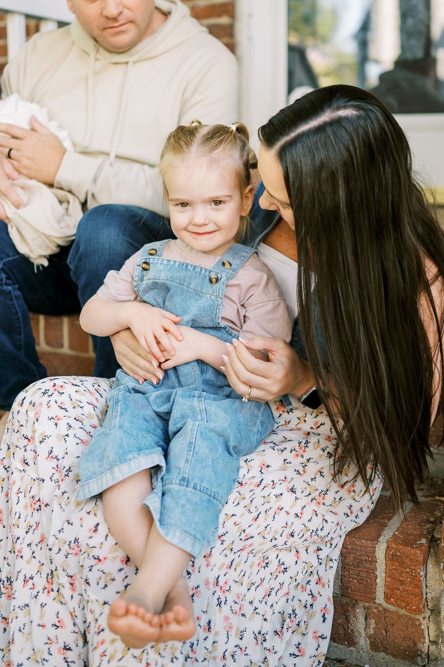 Tender family moments captured on brick steps during an intimate photo session.