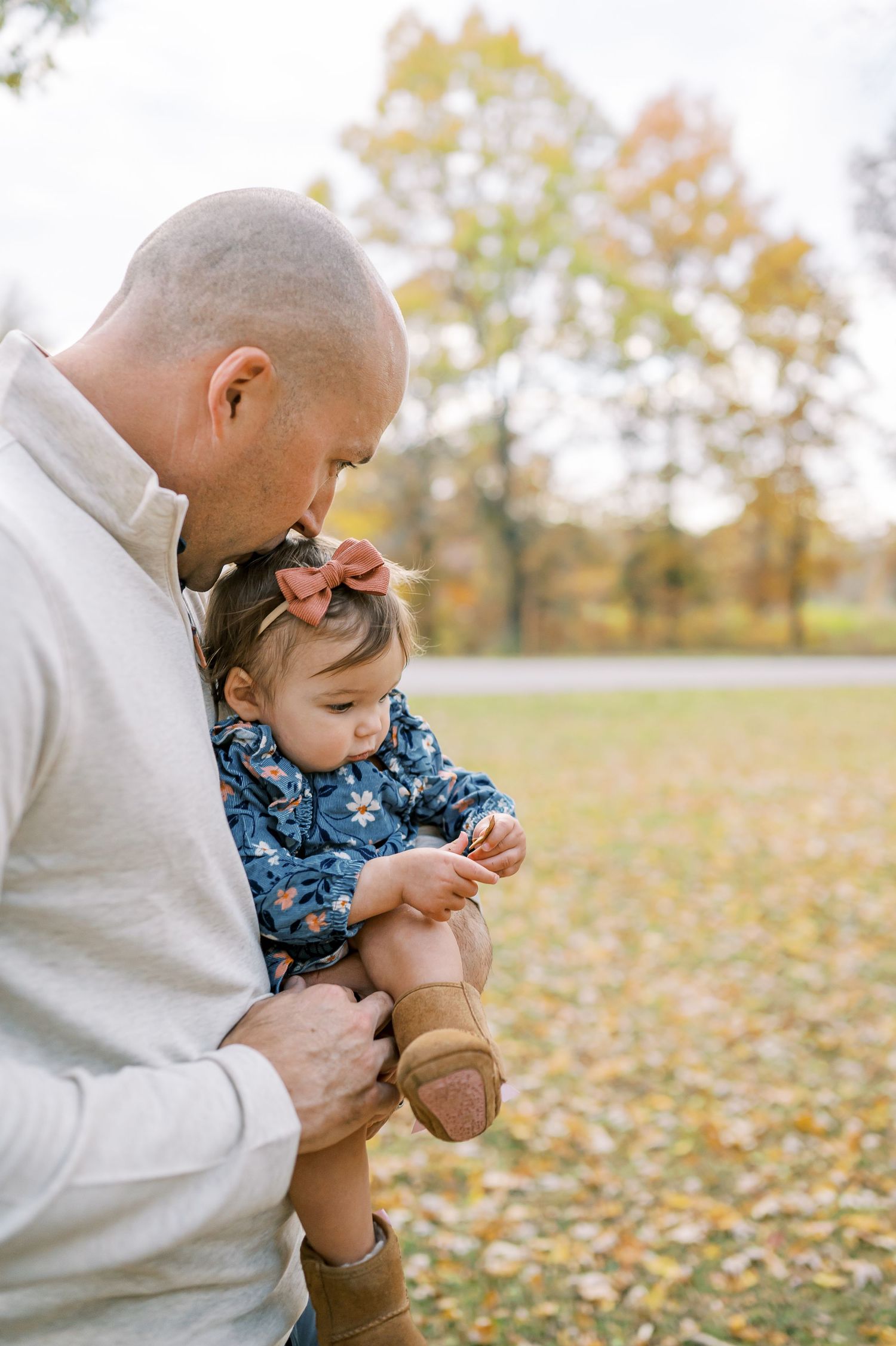 Sweet interaction between parent and child outdoors in fall setting.