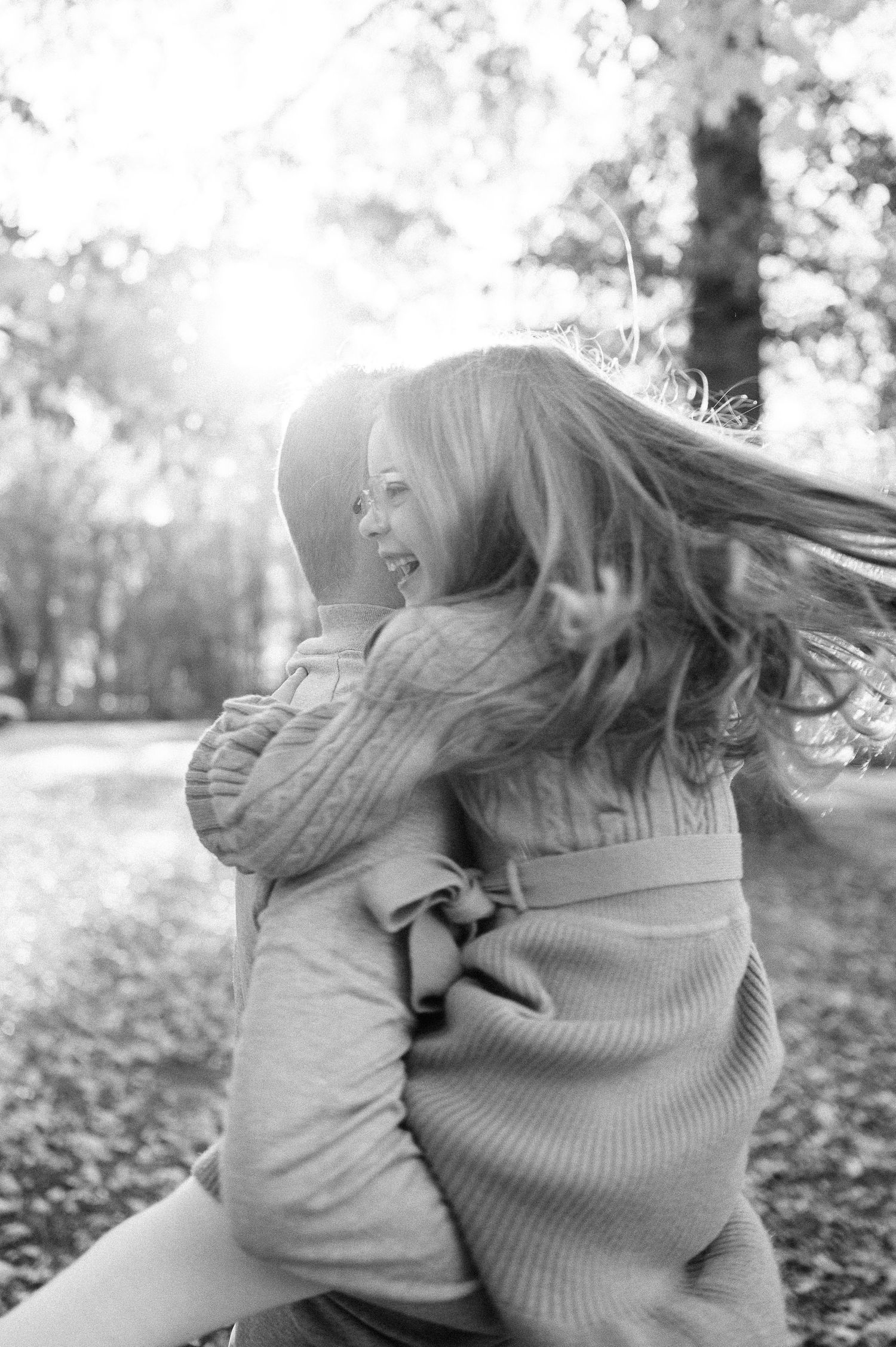 Black and white photo series capturing intimate family moments outdoors.