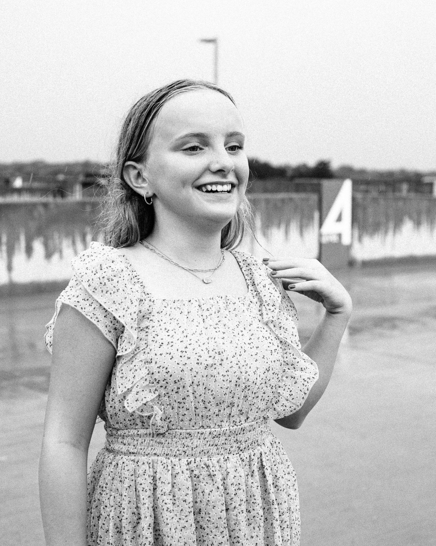 A black and white portrait showing a sparkly dress outdoors.