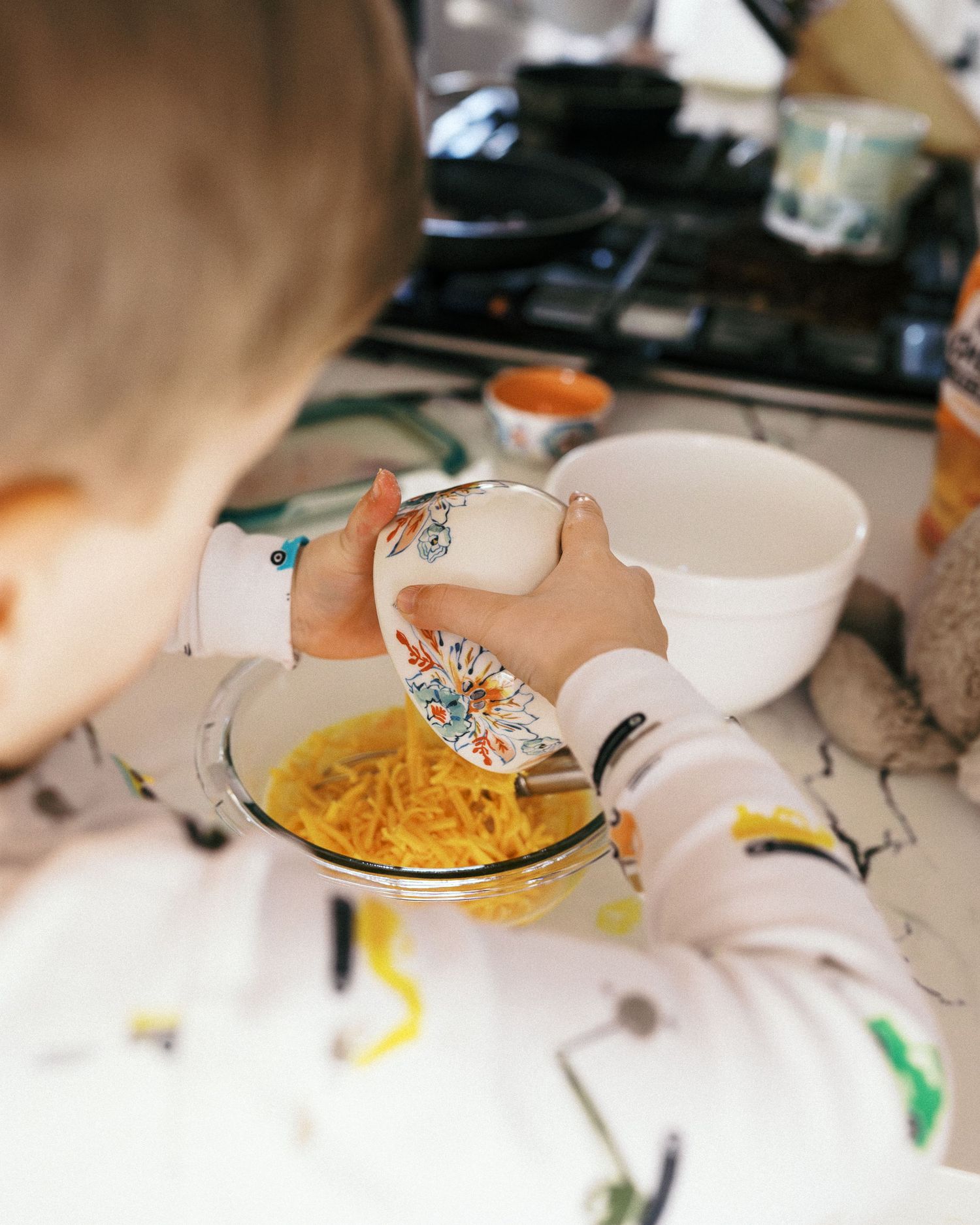Preparing ingredients in white bowls on a marble kitchen counter.
