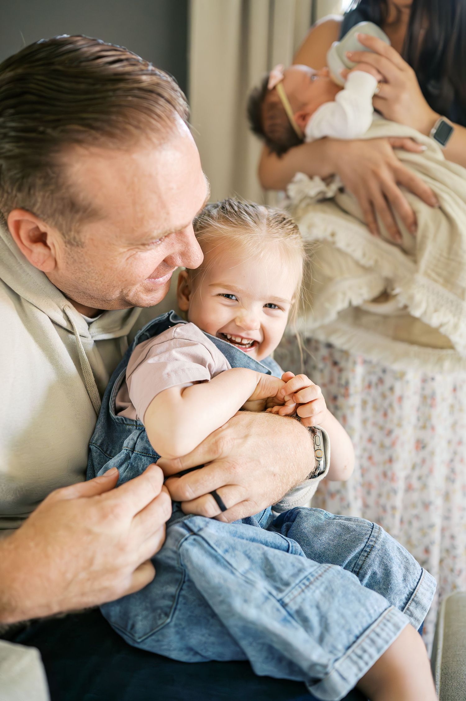 Playful family moments captured during an intimate photo session indoors.
