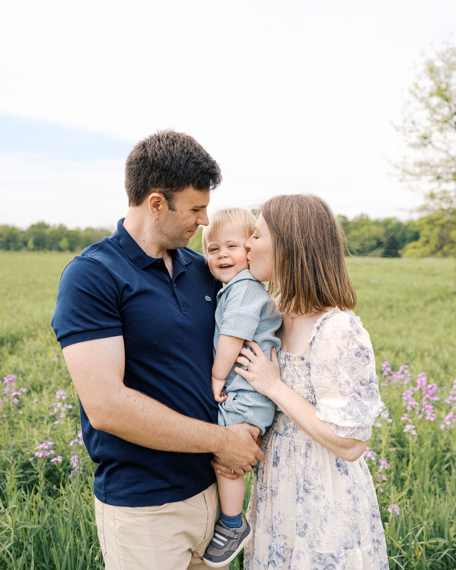 Sweet family moment captured in a series of photos in a wildflower field.