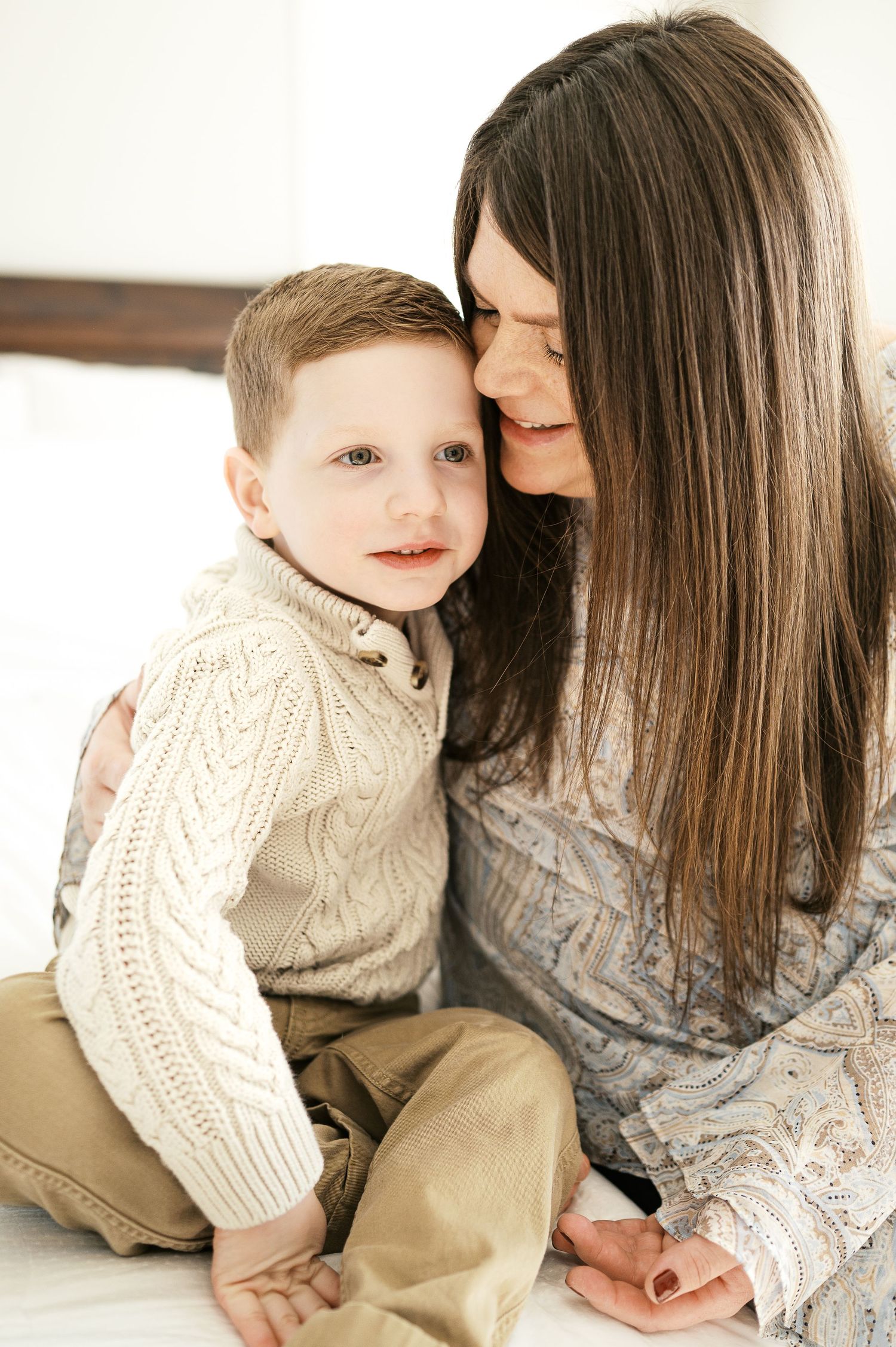 Tender moment between parent and child in cozy indoor setting.