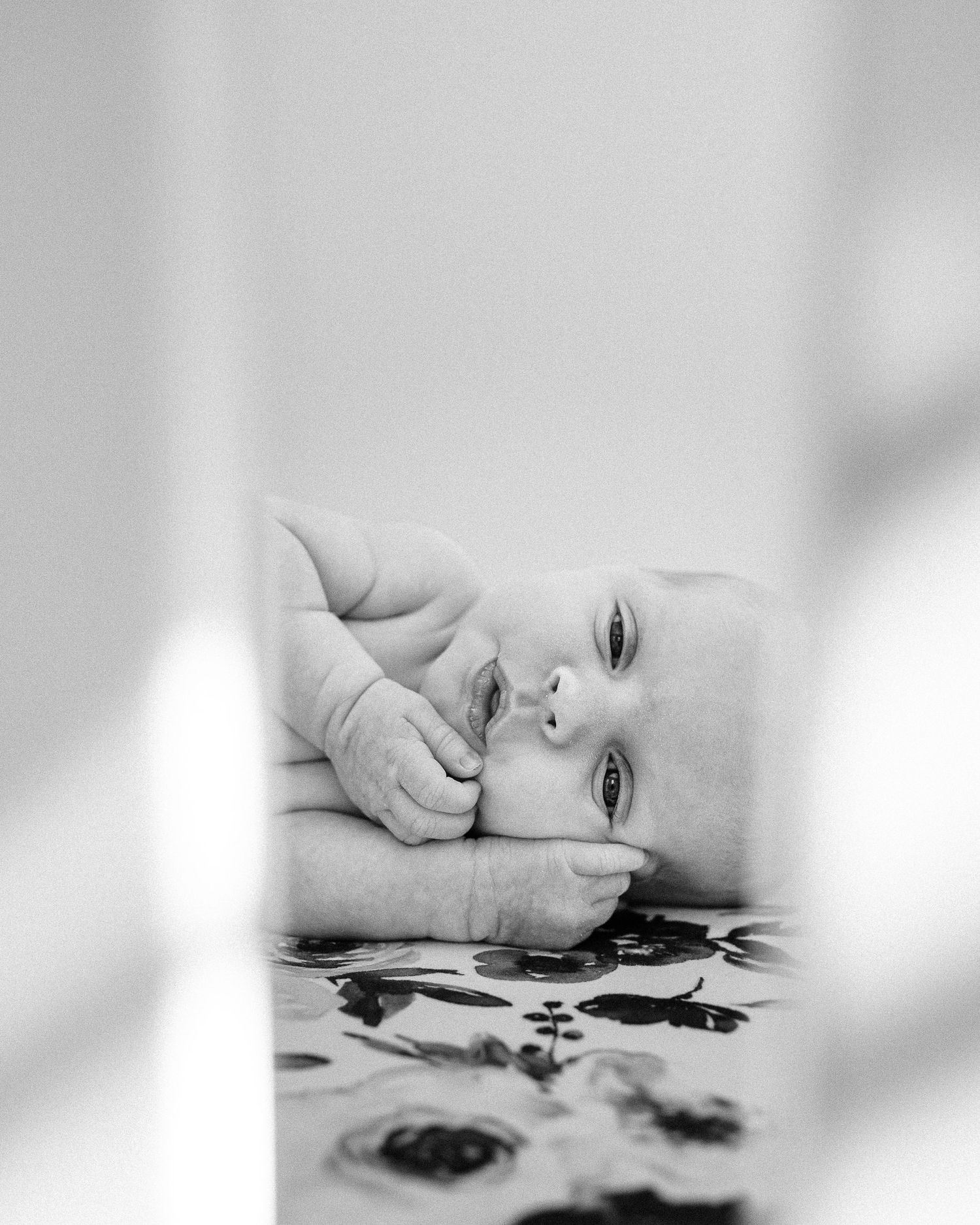 Artistic black and white portrait series showing tender infant moments.