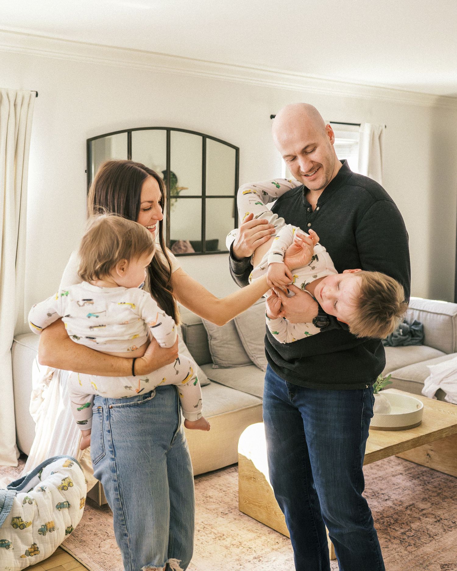 A sequence of candid family interactions showing playful moments on a pink area rug.