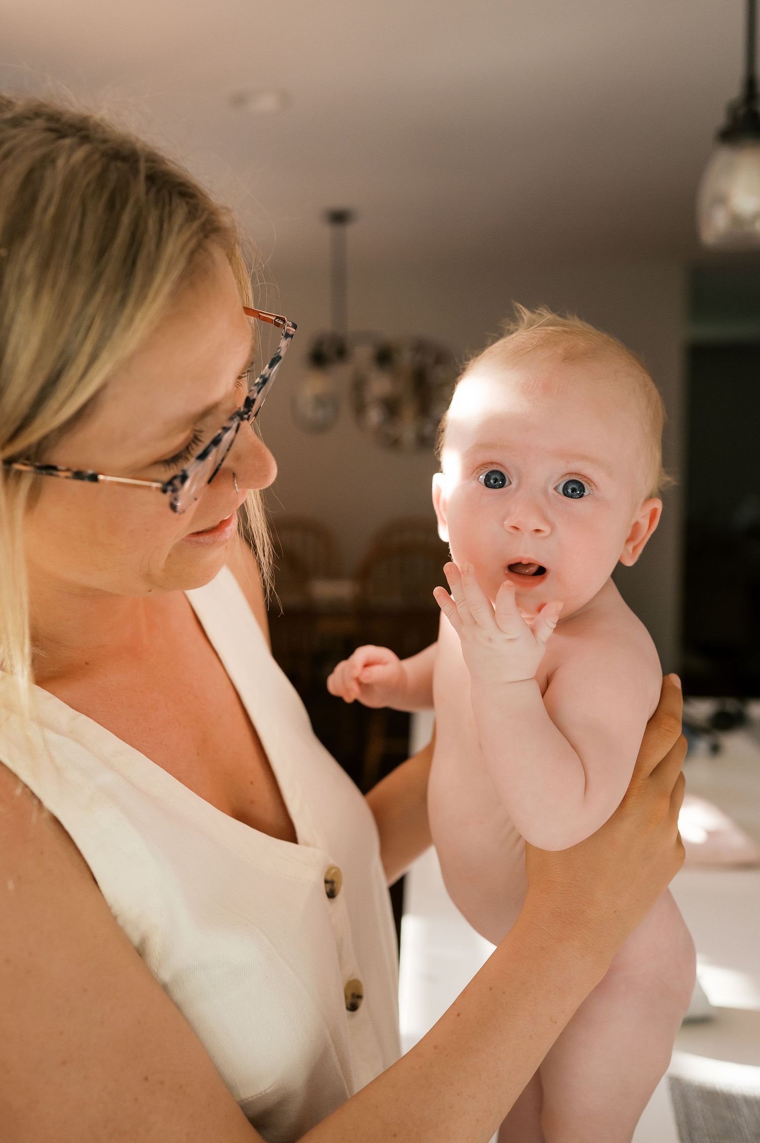 Intimate indoor portrait capturing tender interaction in natural window light.