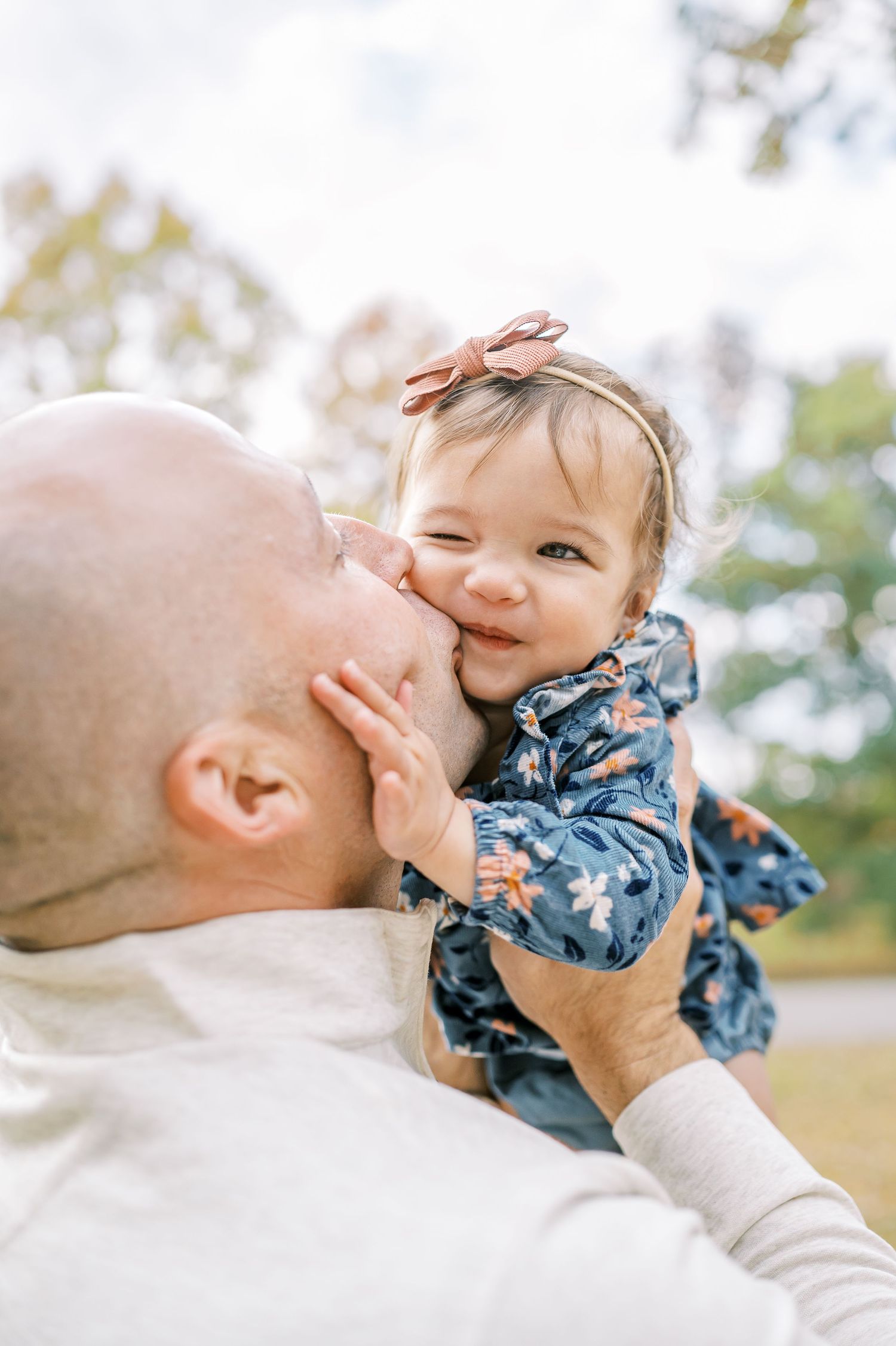 Sweet tender moment of affection shared between parent and child outdoors.