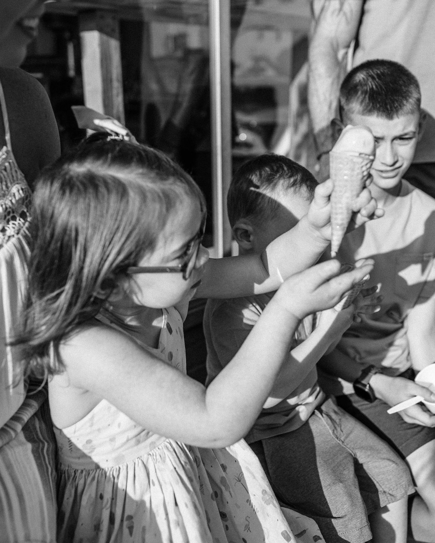 Black and white image of children playing at an indoor event.