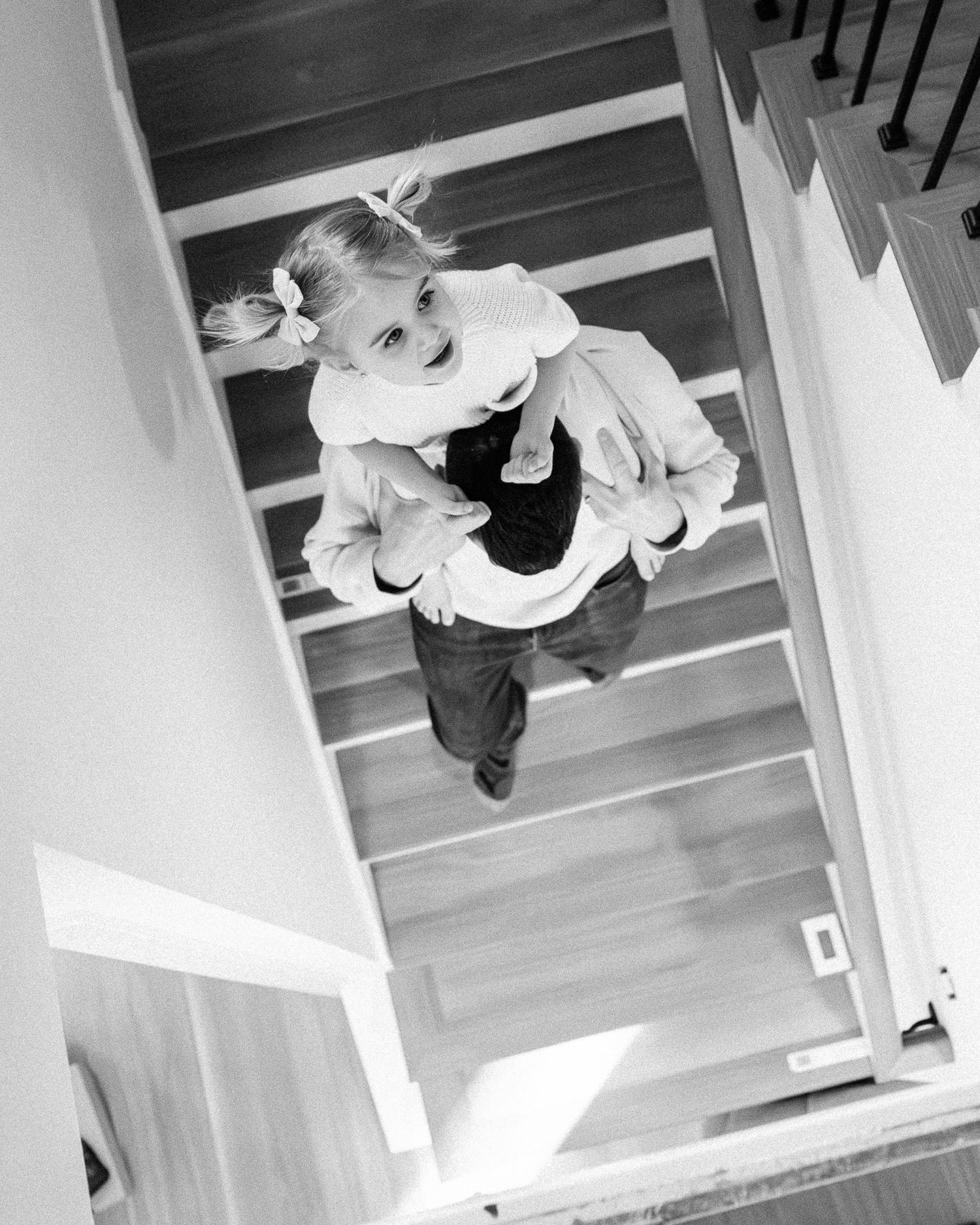 Black and white overhead view of movement on wooden stairs.