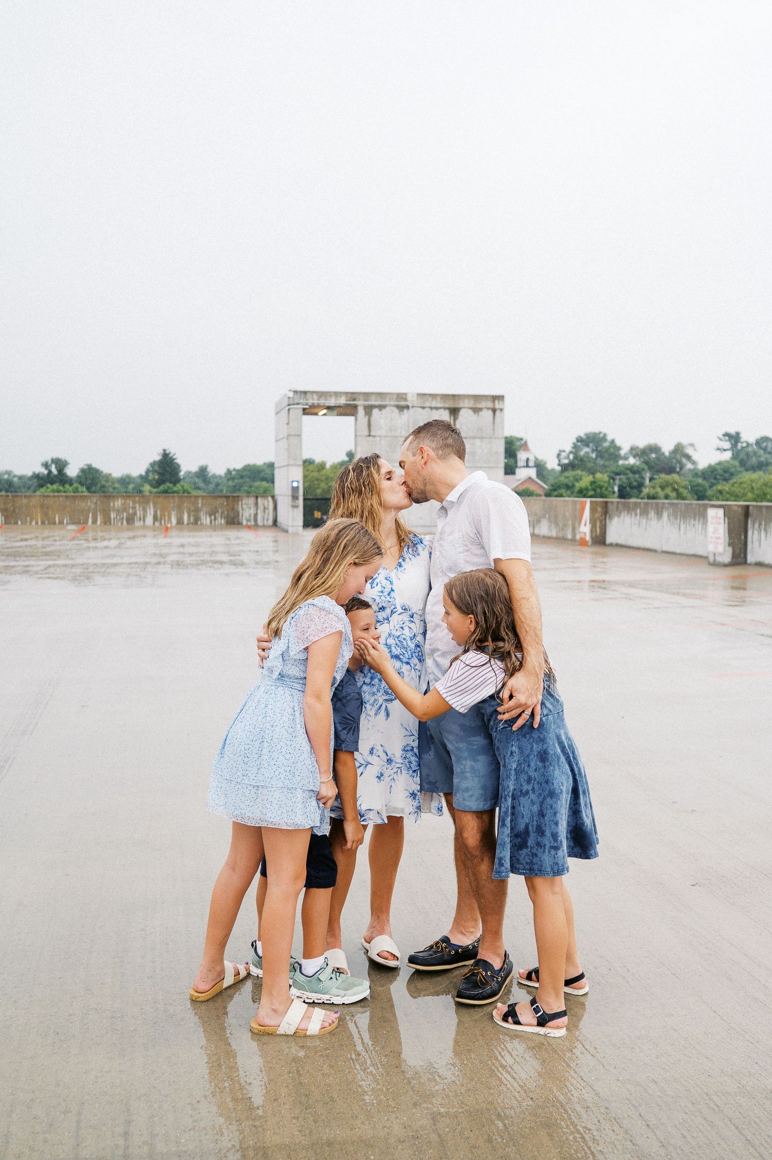 Family members bonding together on a rainy day wearing casual outfits.