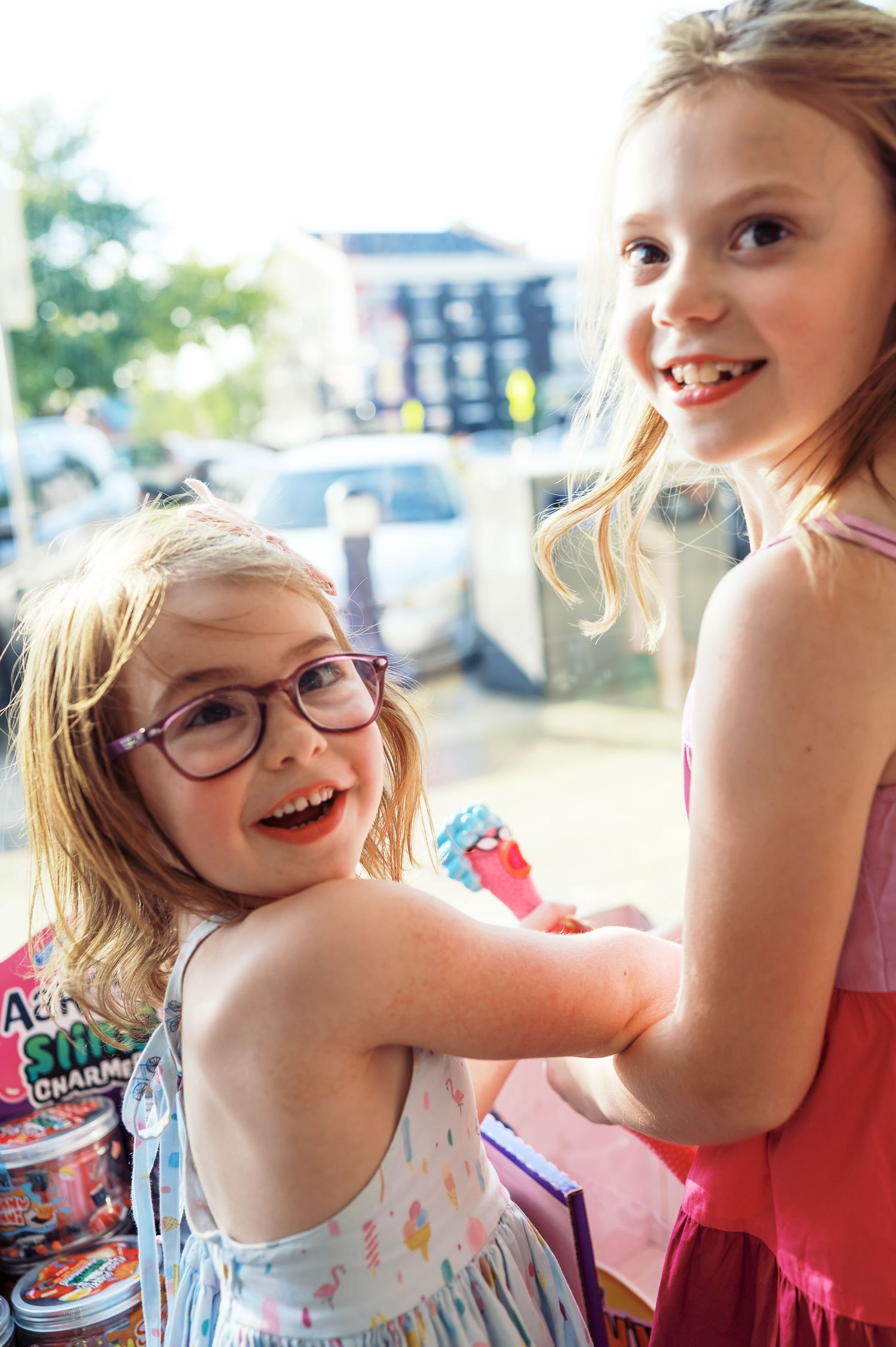 Two children sharing joyful moment while shopping at an ice cream store.