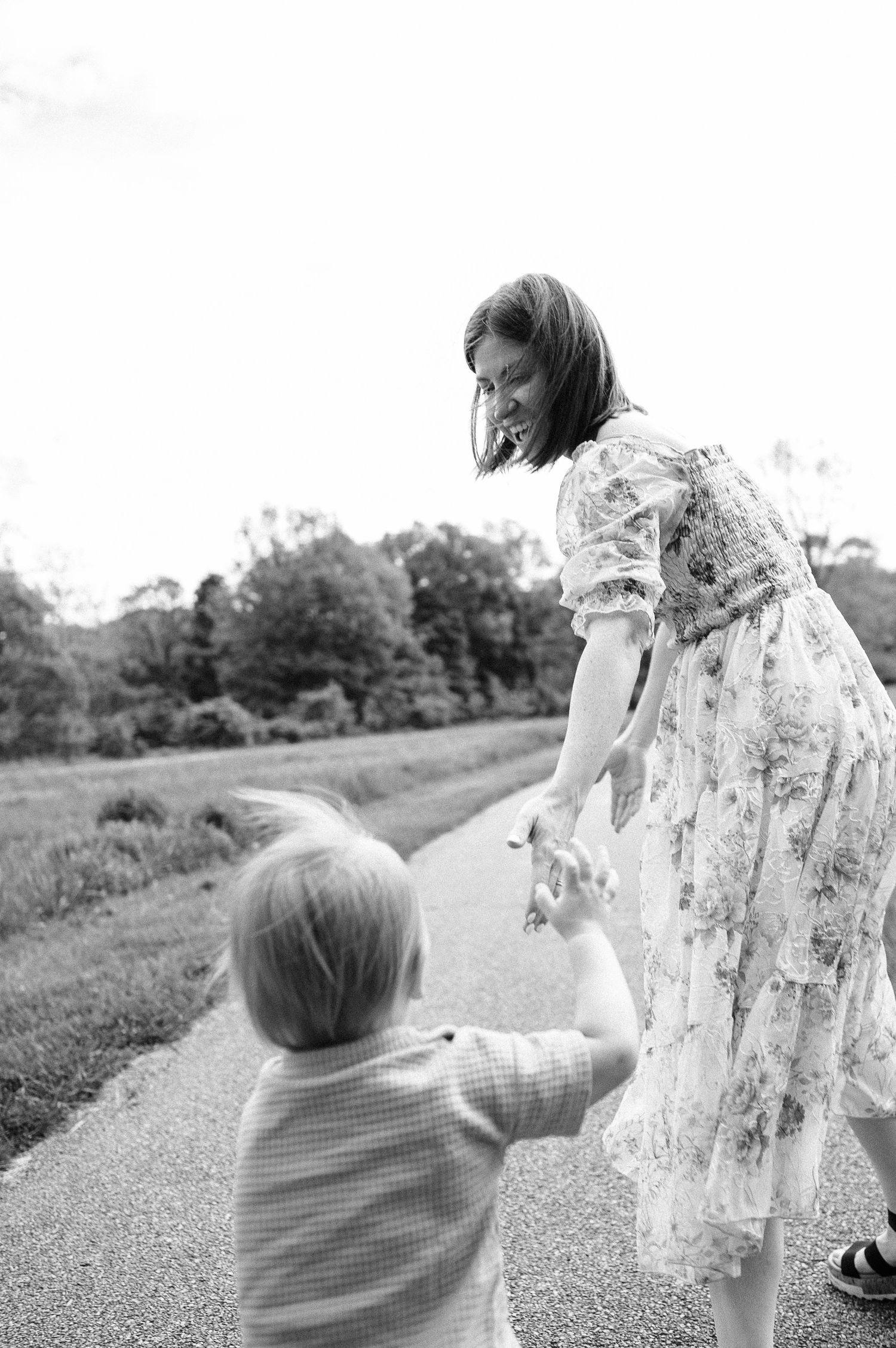 A joyful moment captured in a series of black and white photos showing playful interaction in a park.