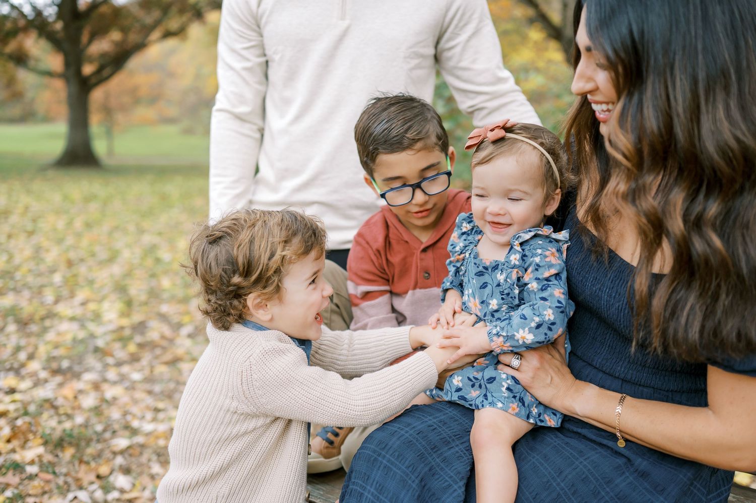 Casual family moments captured outdoors during autumn photo session.