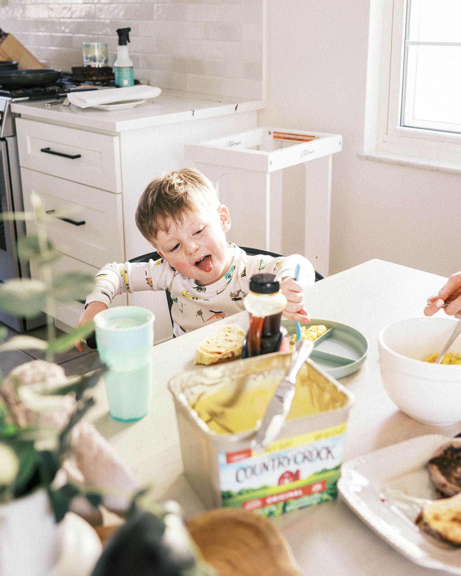 Breakfast preparation with cereal bowls and ingredients on a white kitchen counter.