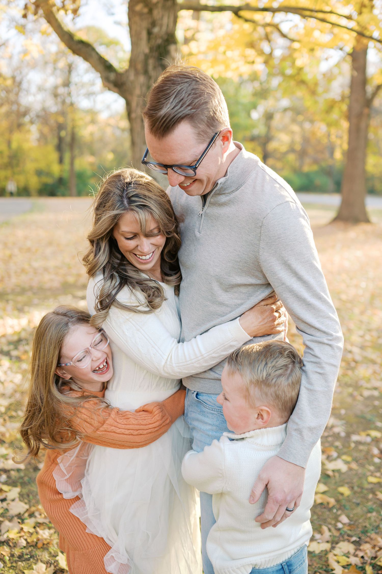 Joyful family moment captured outdoors with everyone hugging and laughing together.