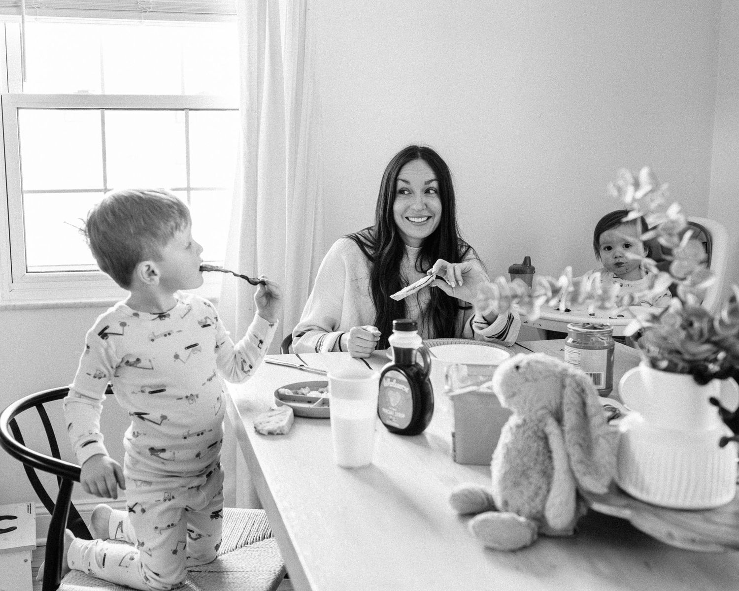 Family mealtime scenes captured in black and white photos around a dining table.
