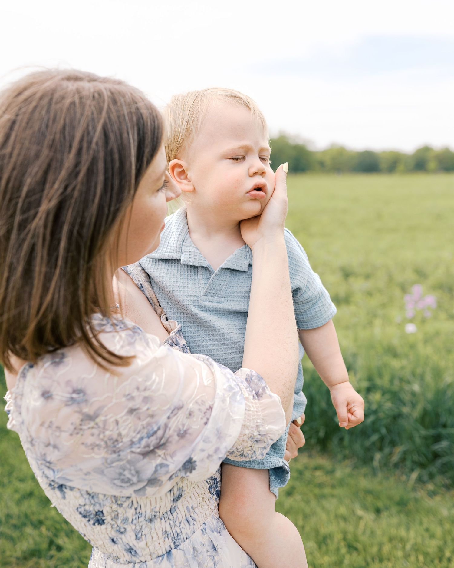 Candid family interactions captured in a flowering meadow during springtime.