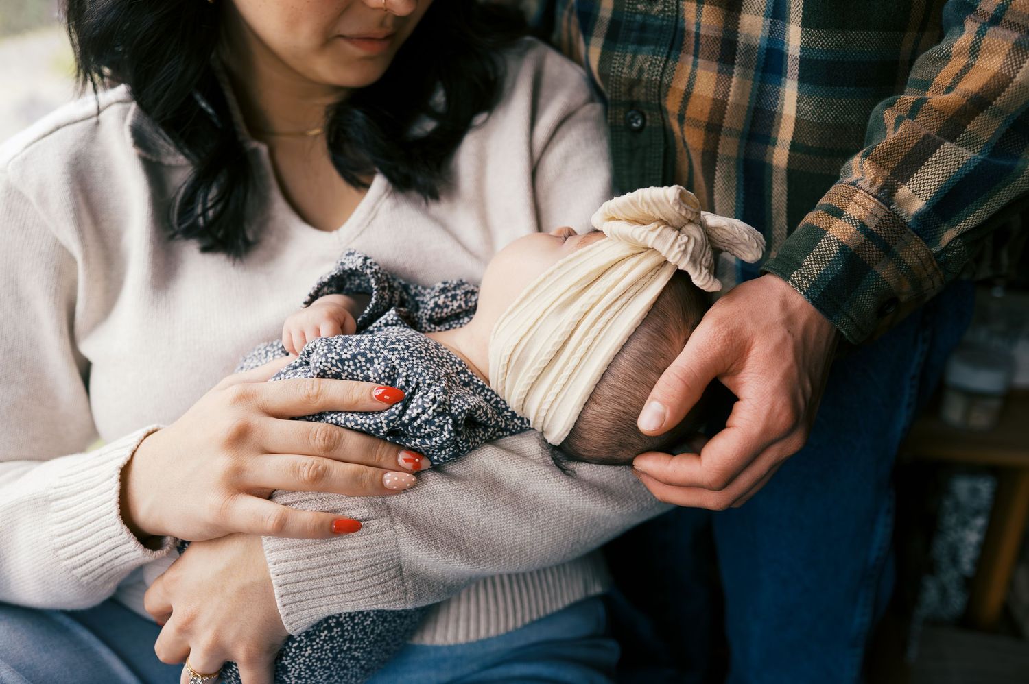 Close-up shots of hands holding and feeding a small baby with a bottle in various positions.