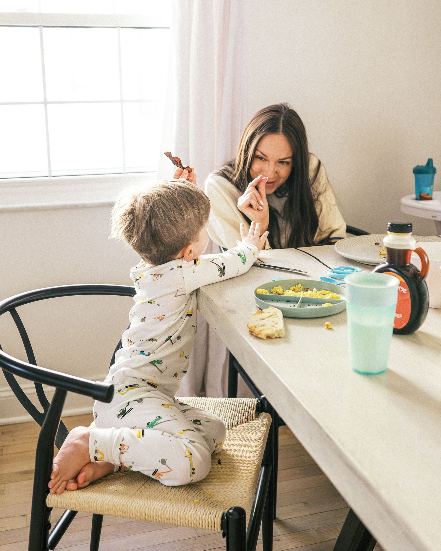 A peaceful mealtime scene with natural light streaming through windows into a modern dining space.