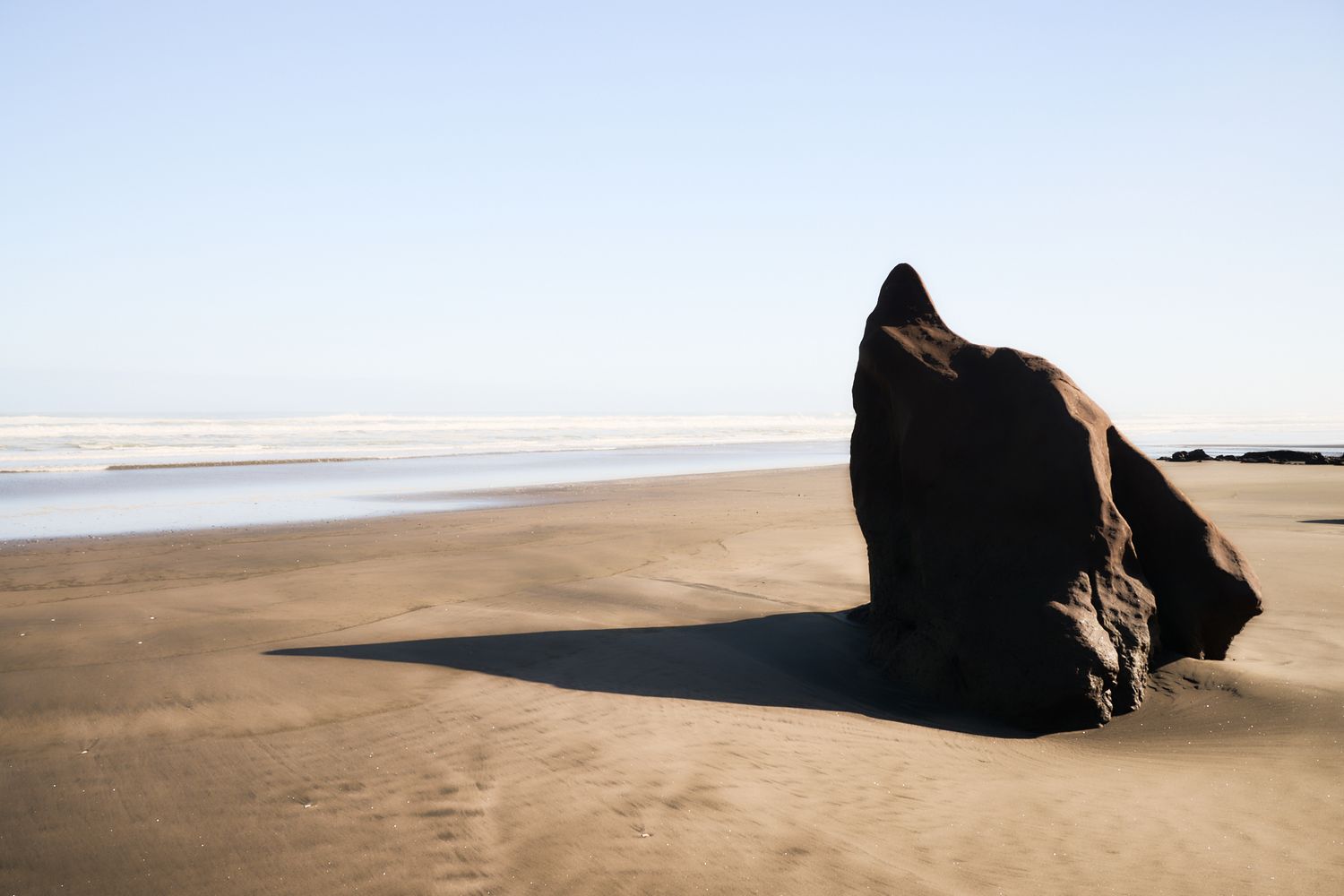 Large stone on the beach Shadows are the reflections of the past