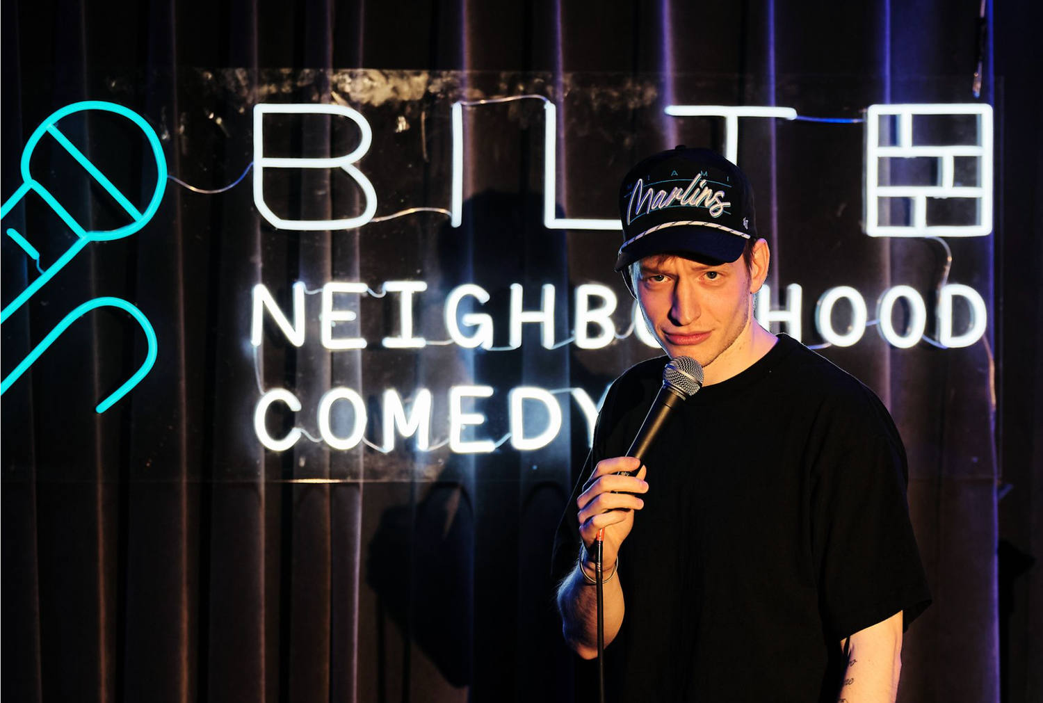Comedian performing stand-up on stage at the Bilt Comedy Show in Washington DC. Live event photography.