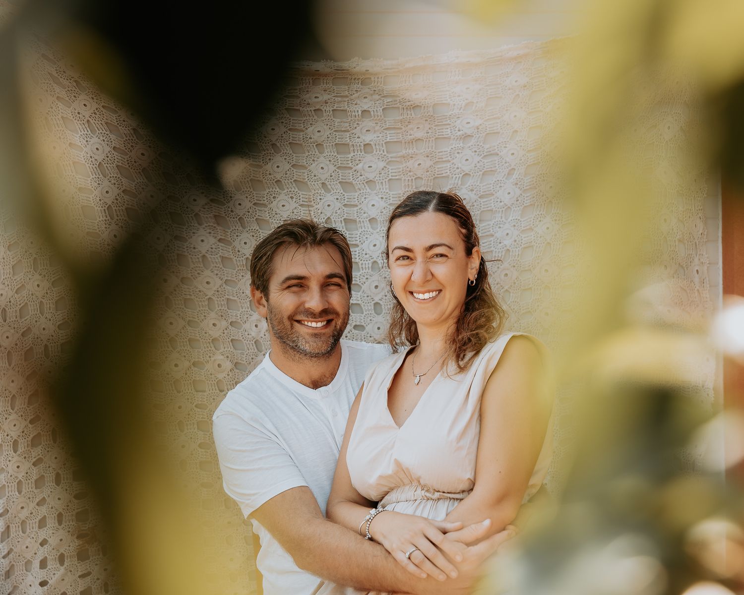 Candid couple's photography session showing tender moments through yellow foliage.