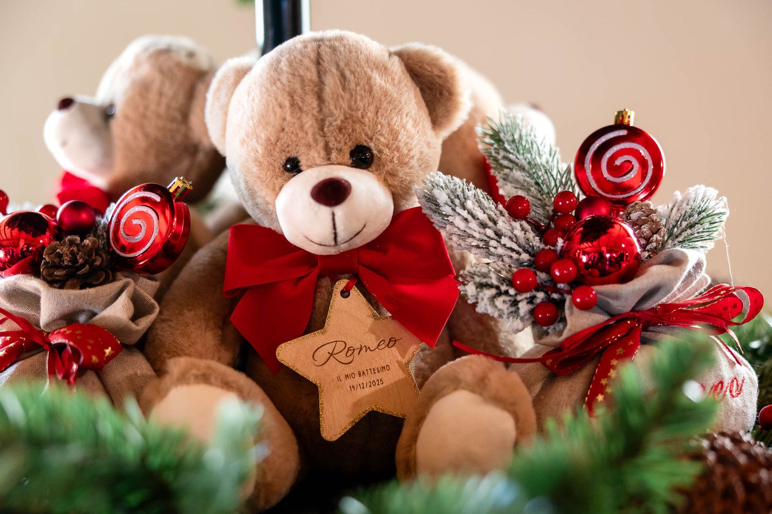 Brown teddy bear with red bow and star tag surrounded by Christmas ornaments, candy canes, and festive decorations.
