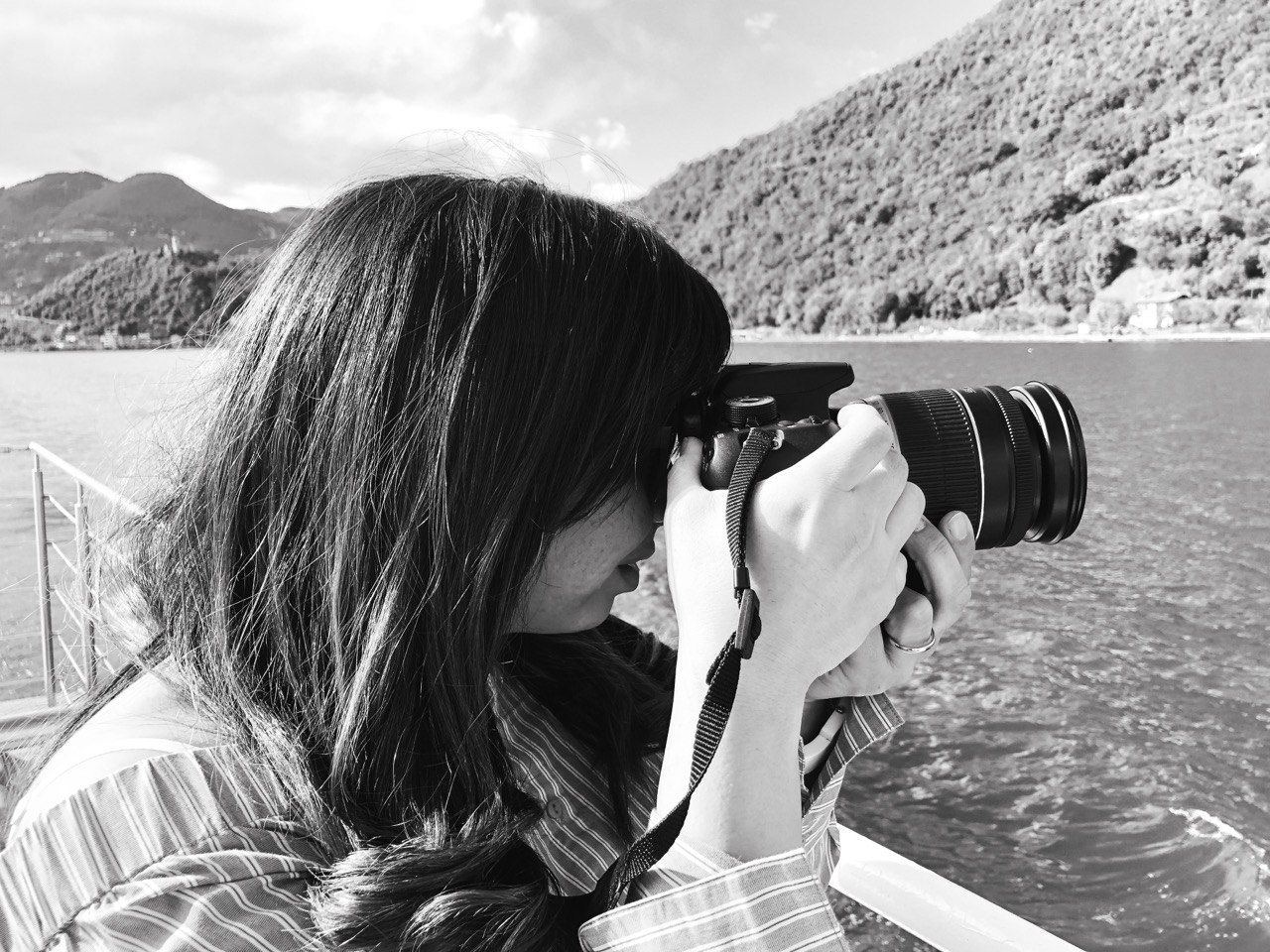 Scenic mountain lake landscape with camera equipment in the foreground.