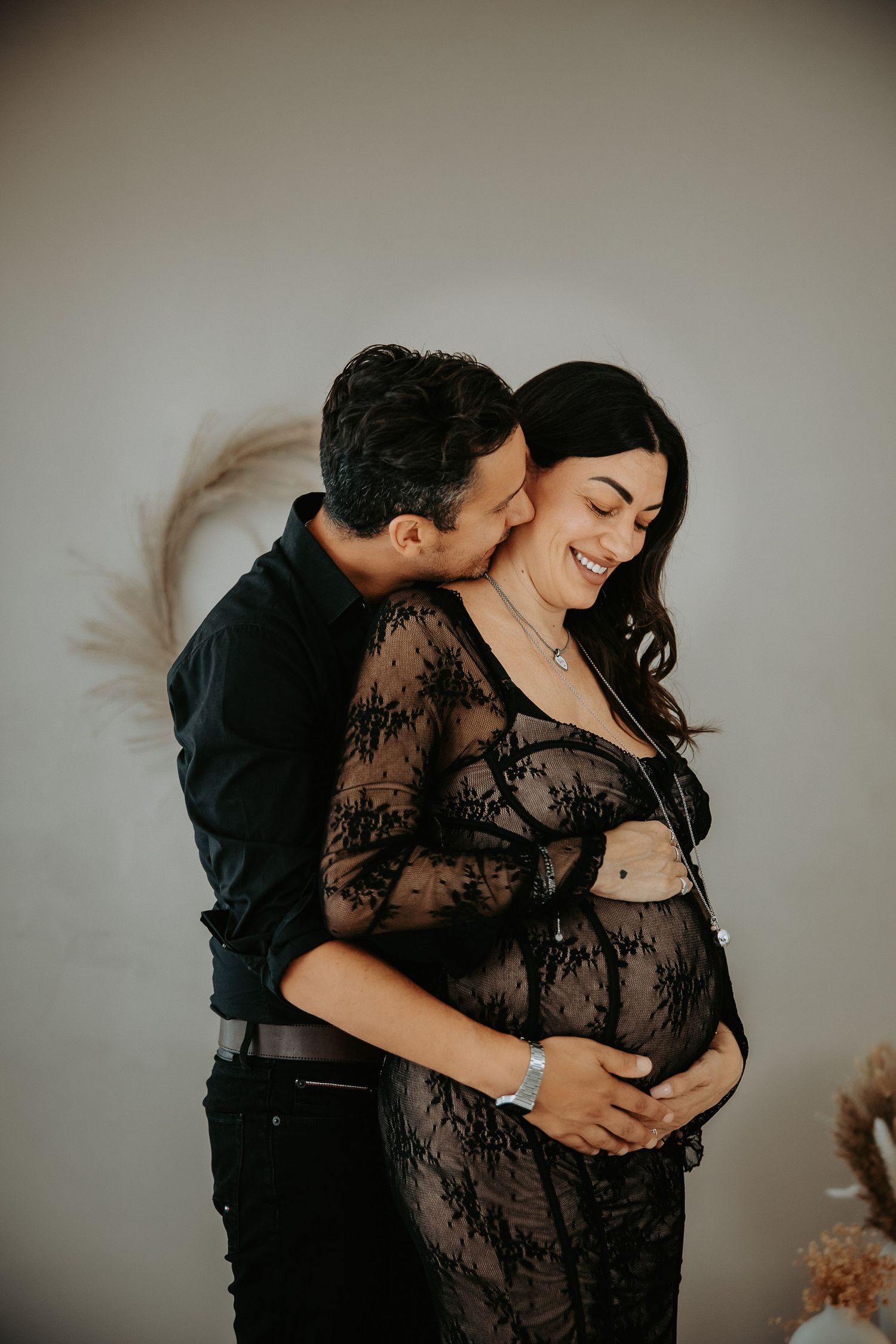 papà che abbraccia la futura mamma durante shooting gravidanza in studio a Milano