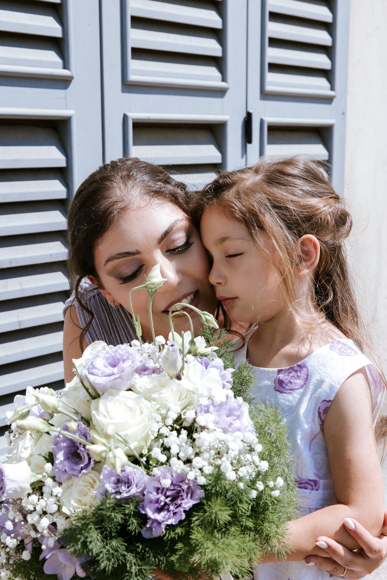 A sequence of romantic photos showing a couple with white and purple flowers against a white shutter background.