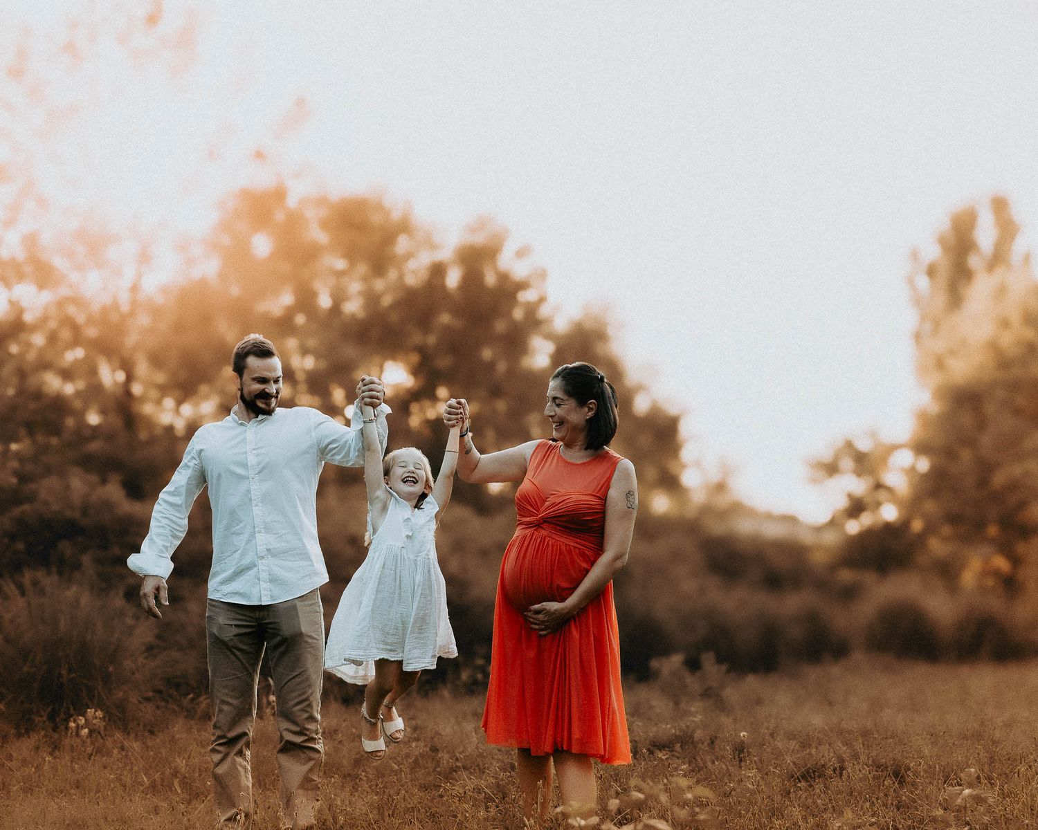 Famiglia in dolce attesa con bambina durante servizio gravidanza lifestyle al tramonto al parco Lambretta a Milano