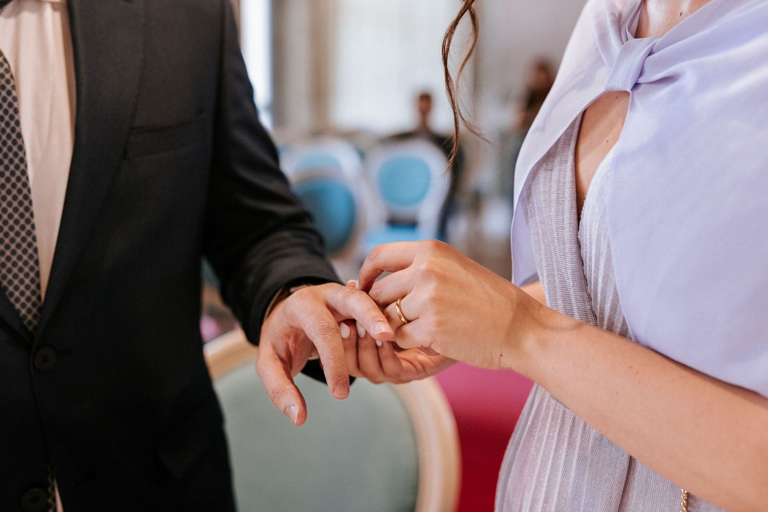 Close-up view of hands exchanging business cards during a professional networking event.