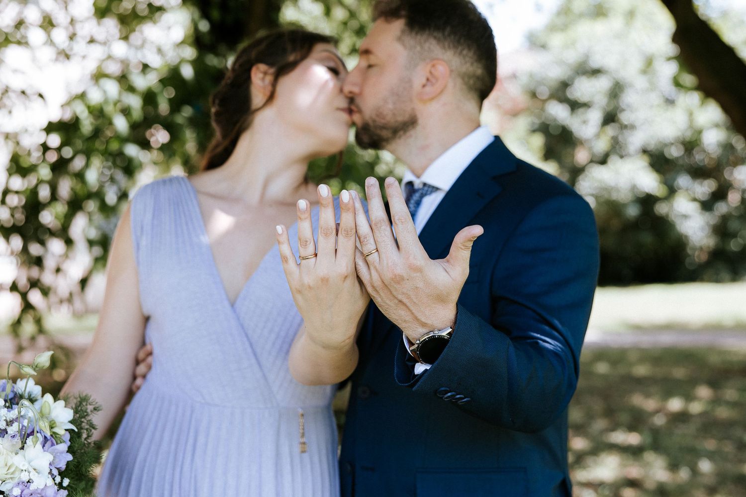 Romantic engagement photos showing tender moments and a sparkling ring in natural lighting.