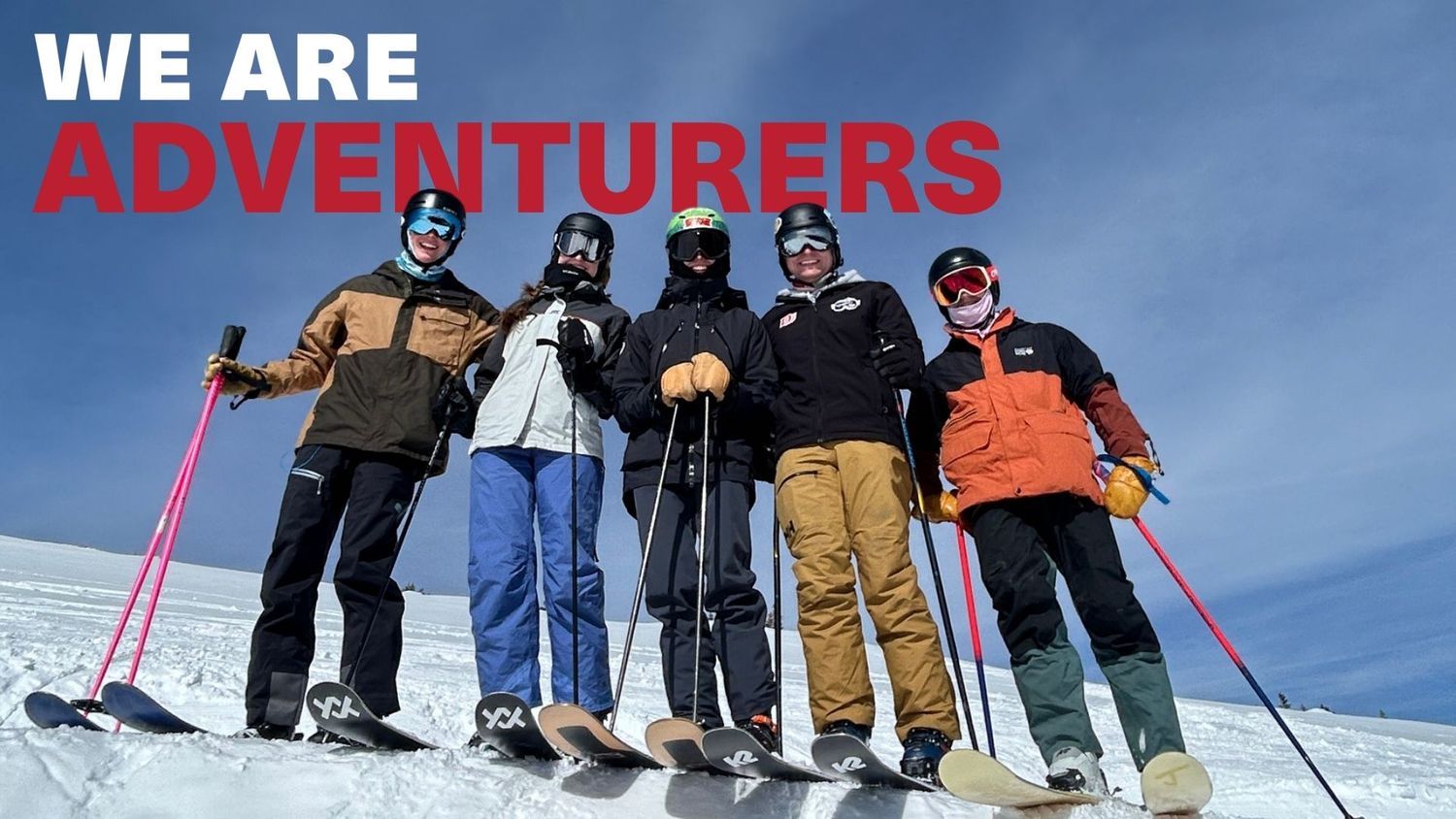 Five skiers pose together on a snowy mountain slope with text reading We Are Adventurers overhead.